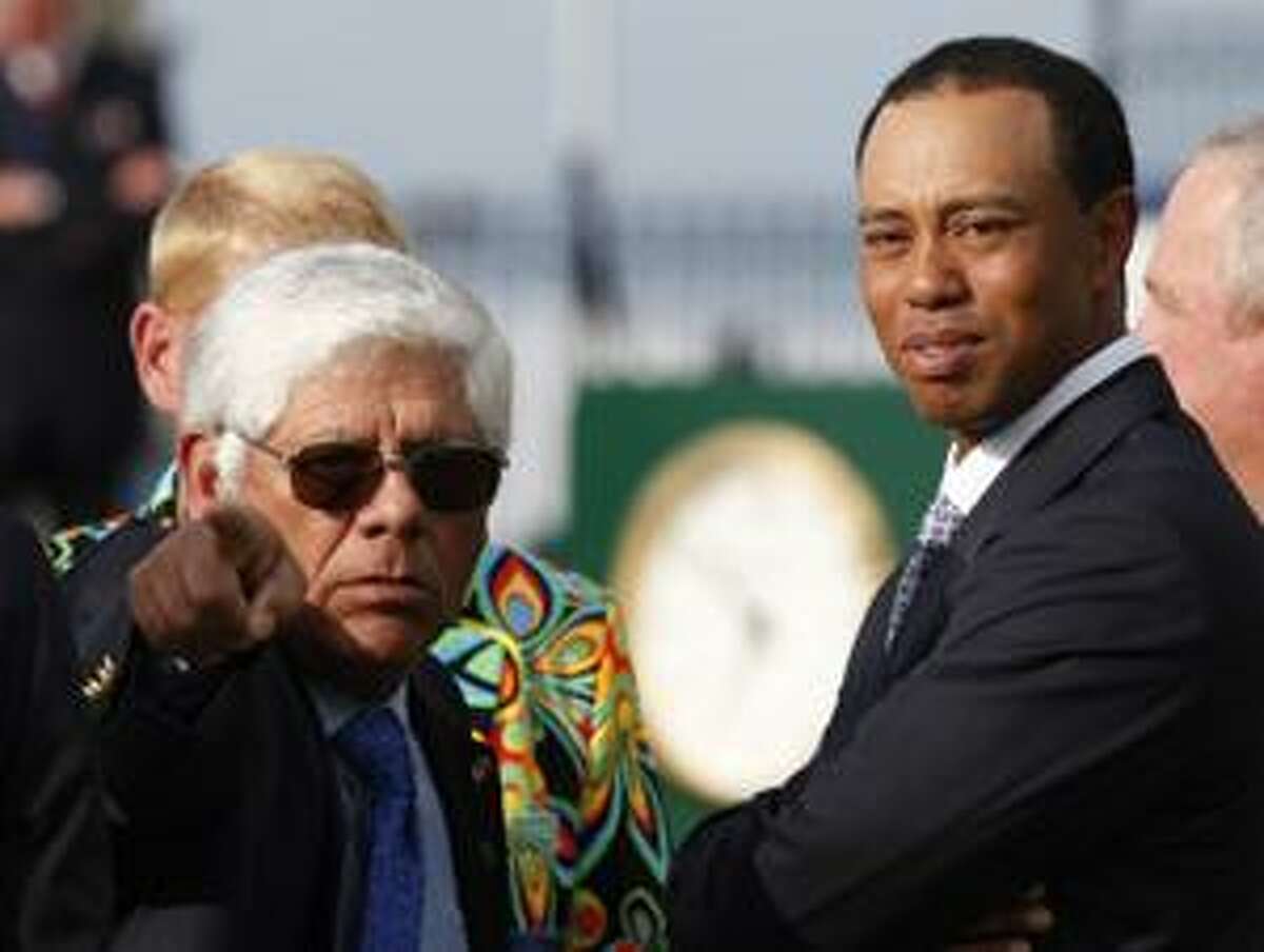 Former British Open Champions Lee Trevino of the U.S., left, and Tiger Woods of the U.S., talk before the group photo of the former champions on the 1st tee on the Old Course at St. Andrews, Scotland, Tuesday, July 13, 2010. 28 Champions have accepted the invitation to play four holes of the Old Course on Wednesday 14 July, the day before the Open Championship gets underway. (AP Photo/Mark Baker)