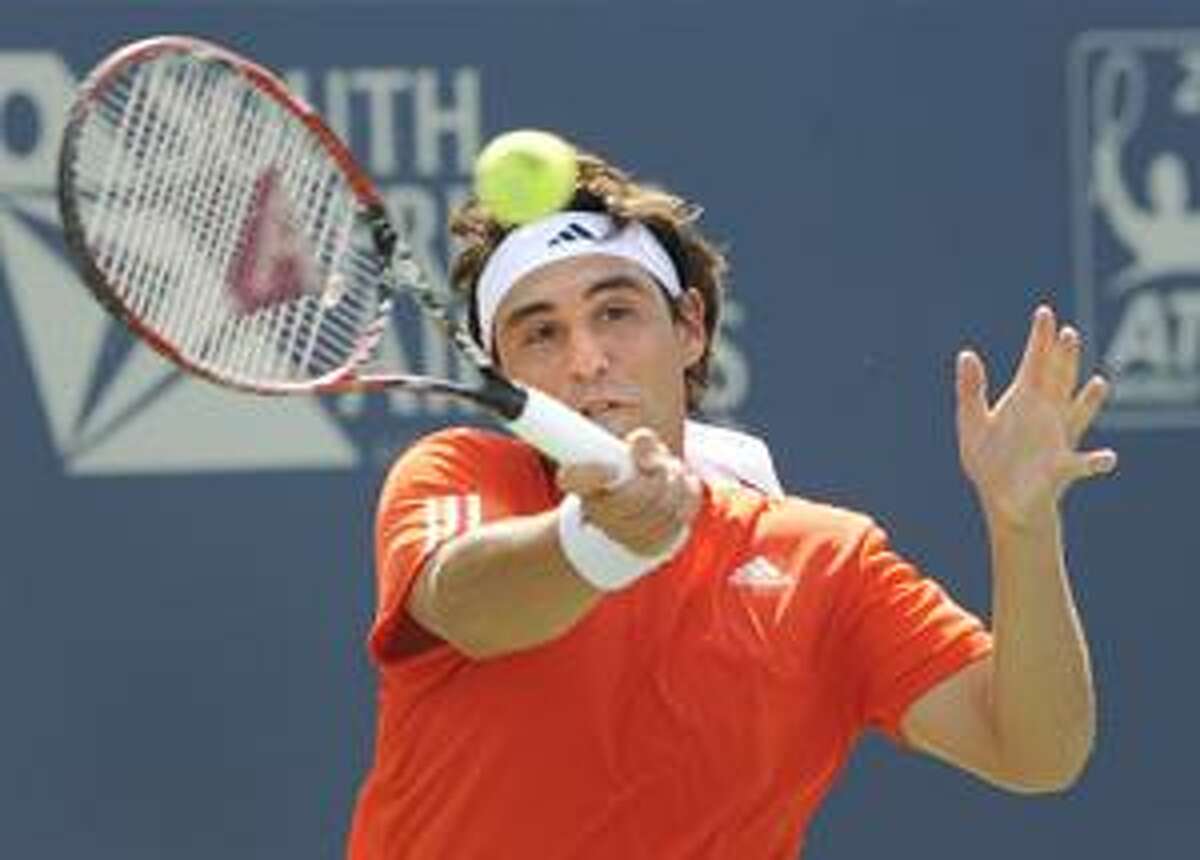 AP Marcos Baghdatis, of Cyprus, hits a forehand during his 6-4, 6-3 loss to Frederico Gil, of Portugal, in their first round match at the Pilot Pen tennis tournament in New Haven Monday.
