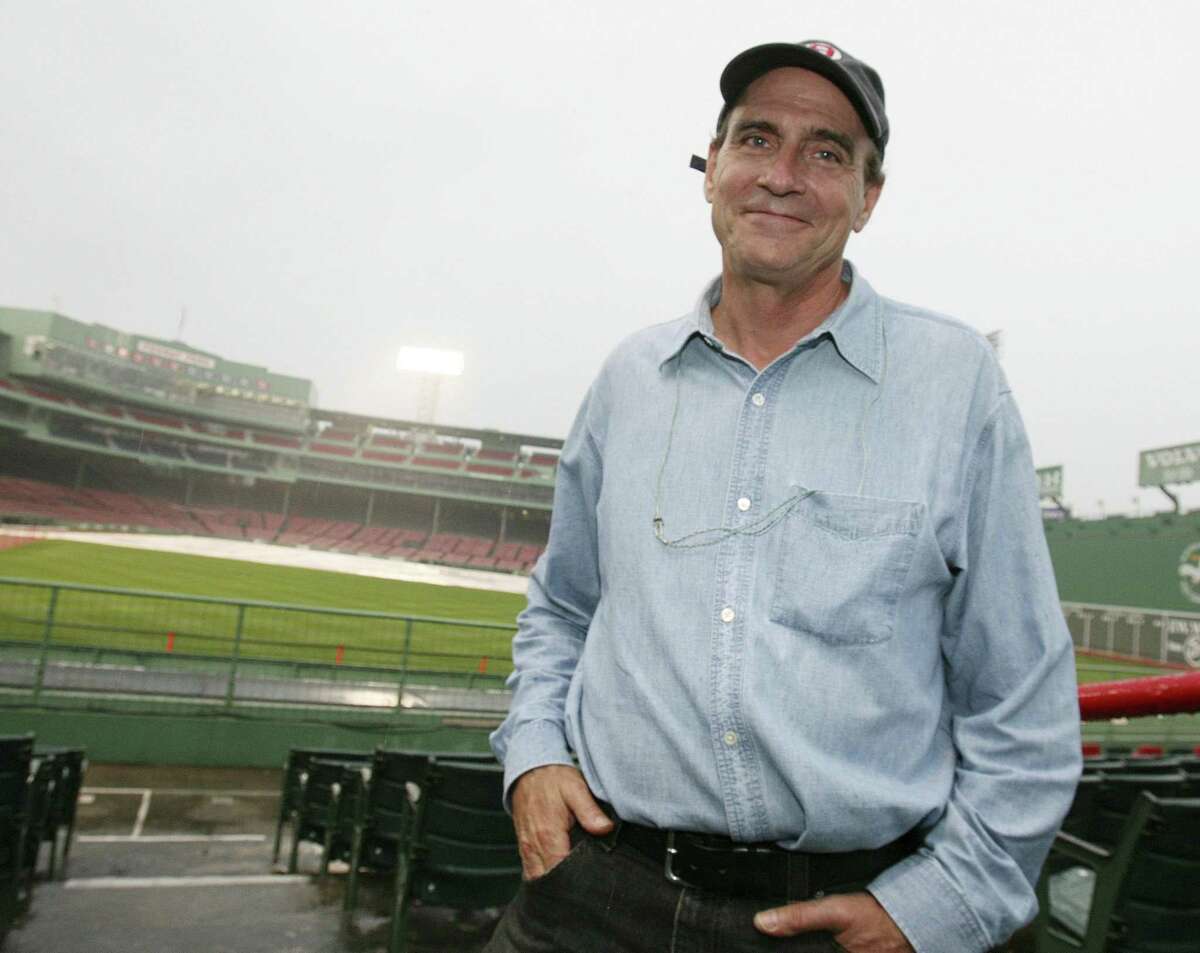James Taylor poses during a rain delay of a benefit concert at Fenway Park in Boston. Taylor is scheduled to perform the U.S. national anthem before the NHL Winter Classic hockey game between the Boston Bruins and Philadelphia Flyers at Fenway Park on Jan. 1. (AP Photo/Michael Dwyer, File)
