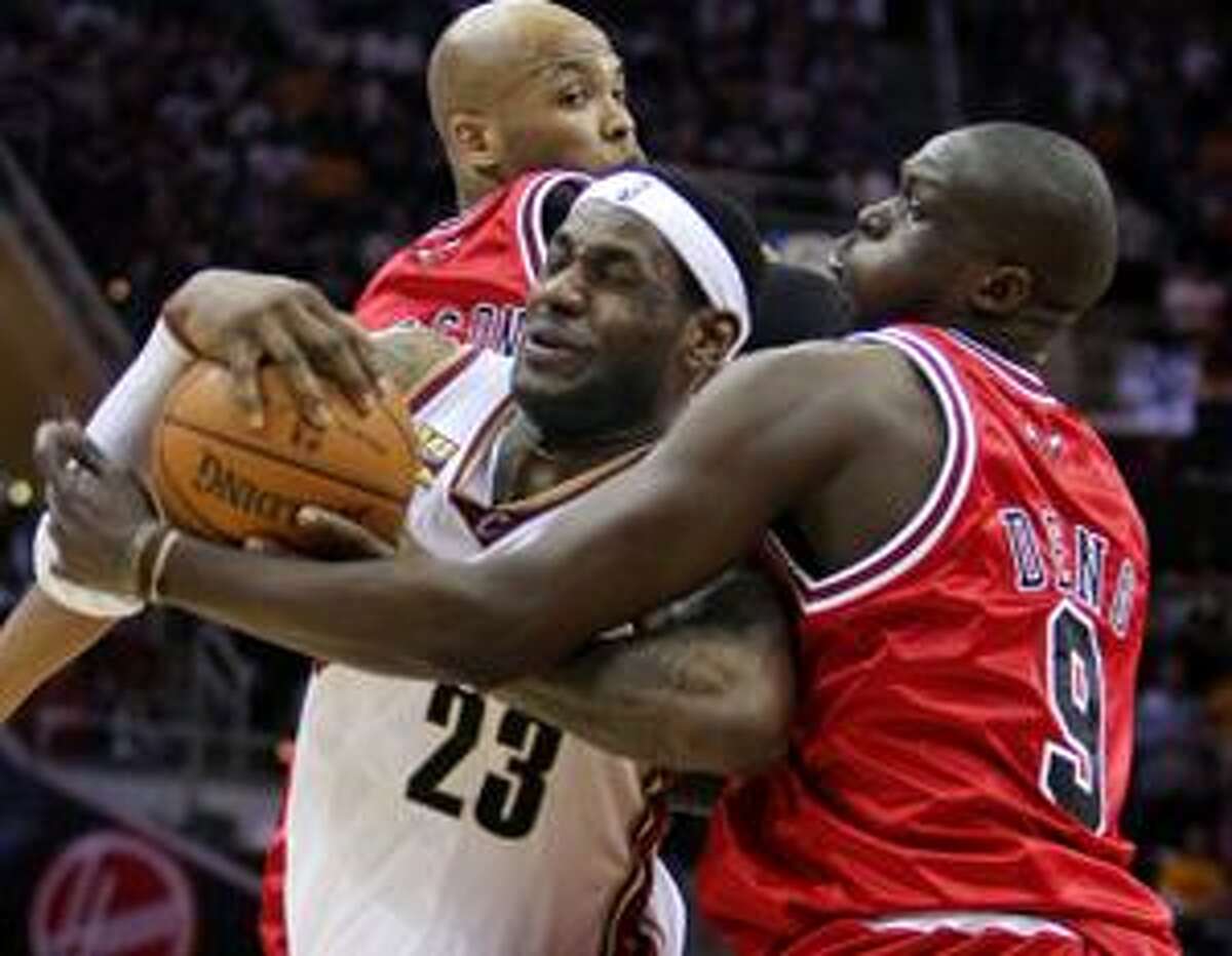AP Cleveland Cavaliers forward LeBron James (23) is fouled by Chicago Bulls forward Luol Deng in the third quarter of Game 5 of a first-round NBA playoff series Tuesday in Cleveland.