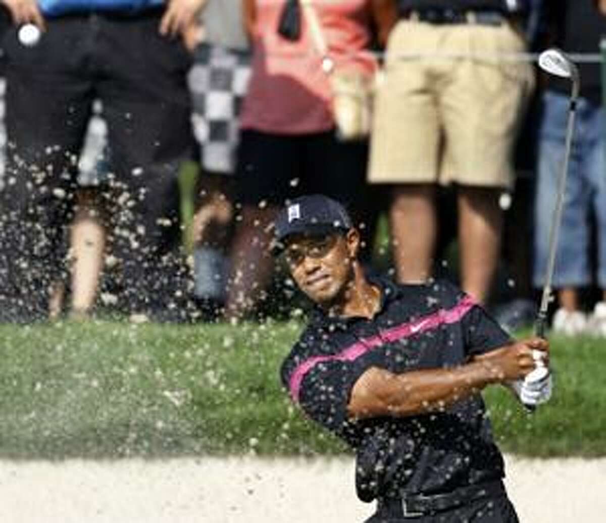 Tiger Woods hits from the 11th bunker during the first round of The Barclays golf tournament, Thursday, Aug. 26, 2010, in Paramus, N.J. (AP Photo/Mel Evans)