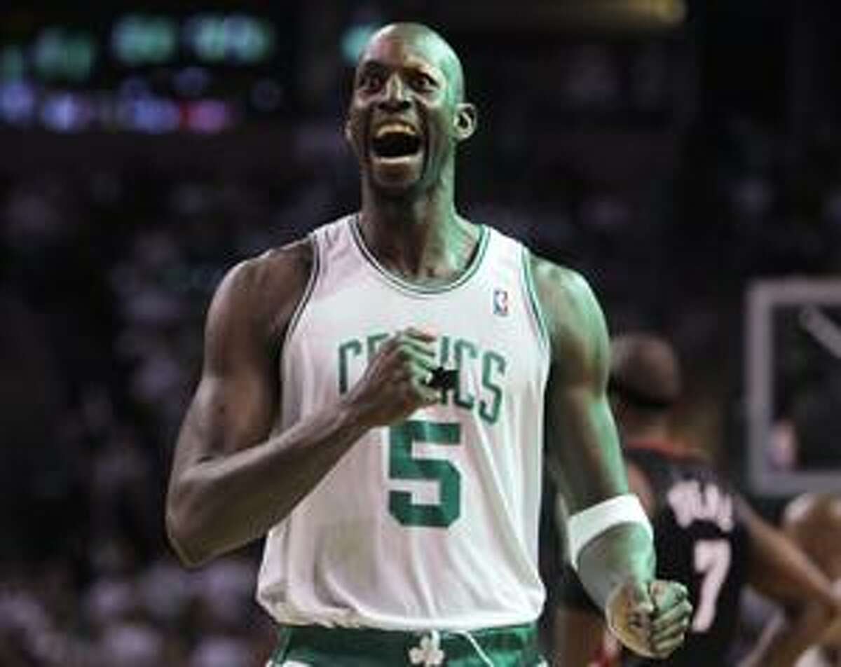 Boston Celtics forward Kevin Garnett pounds his chest as he heads to the court to face the Miami Heat prior to the first half of the first round of their NBA basketball playoff game in Boston, Saturday, April 17, 2010. (AP Photo/Charles Krupa)