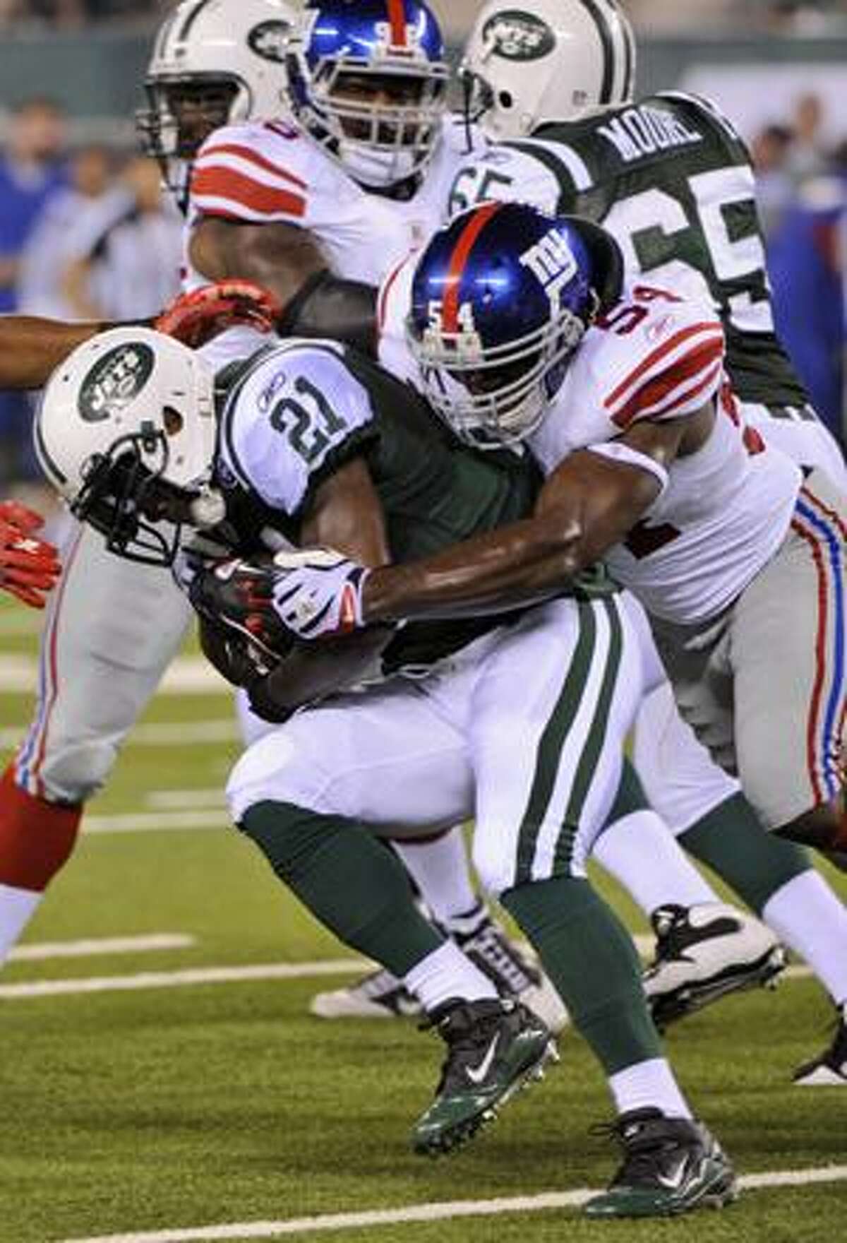 New York Jets' LaDanian Tomlinson is tackled by New York Giants' Jonathan Goff during the first quarter of a preseason NFL football game at New Meadowlands Stadium in East Rutherford, N.J., Monday, Aug. 16, 2010. (AP Photo/Bill Kostroun)