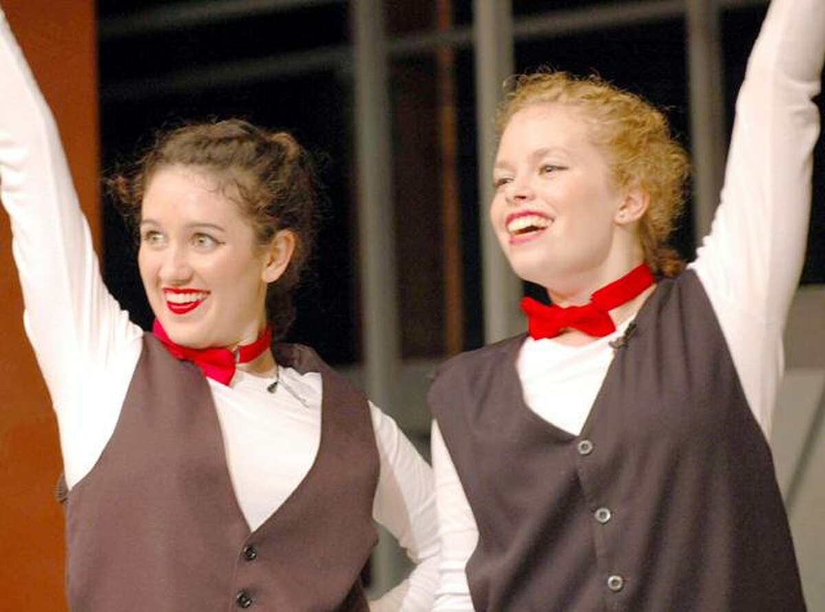 Ashley Moret, left, and Adrienne Camm, right, salute to "Steamed Heat" during a perfomance of "The Pajama Game" at The Gary-The Olivia Performing Arts Center in Bethlehem.