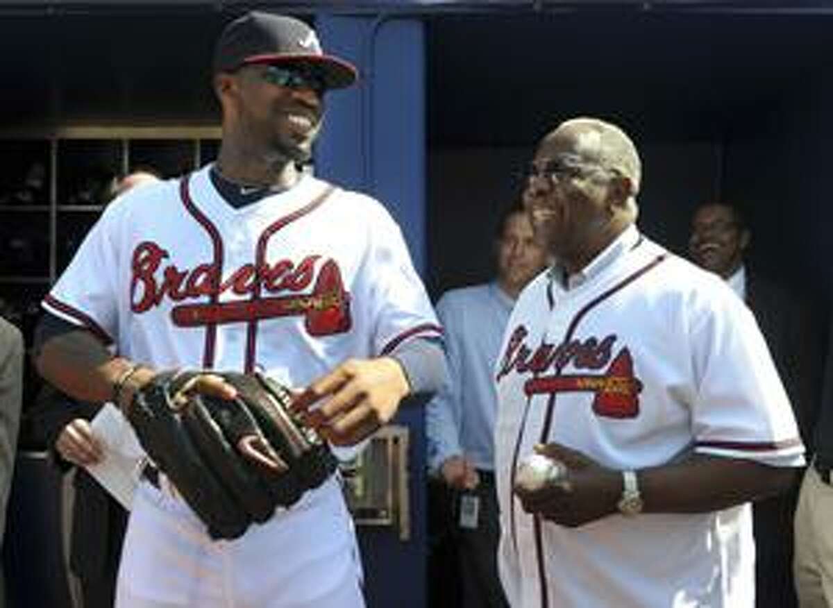 Atlanta Braves executive and Hall of Famer Hank Aaron, right, chats with Braves rookie Jason Heyward before the Braves' baseball game against the Chicago Cubs at Turner Field in Atlanta on Monday, April 5, 2010. Heyward hit a three-run home run in the game, in his first at-bat in the majors. (AP Photo/Rich Addicks)