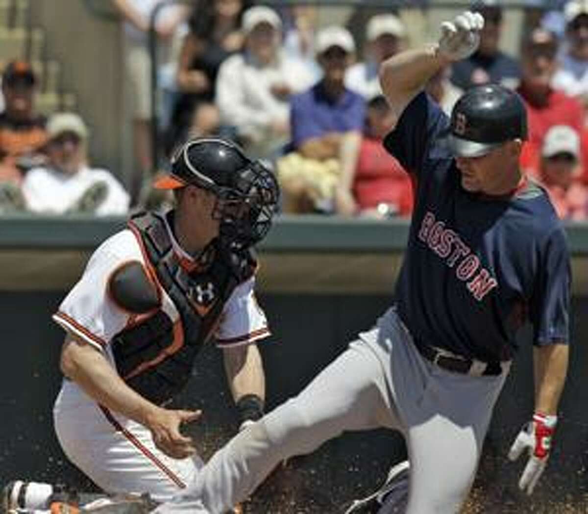 Boston Red Sox's J.D. Drew, right, scores ahead of the tag by Baltimore Orioles catcher Matt Wieters during the second inning of a spring training baseball game Wednesday, March 31, 2010, in Sarasota, Fla. Drew scored on a sacrifice fly by Josh Reddick. (AP Photo/Chris O'Meara)