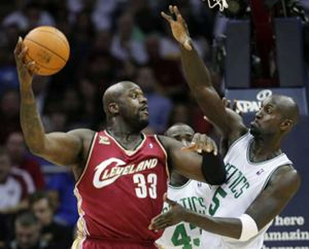 FILE - In this Oct. 27, 2009, file photo, Cleveland Cavaliers' Shaquille O'Neal (33) tries to pass around Boston Celtics' Kevin Garnett during an NBA basketball game in Cleveland.