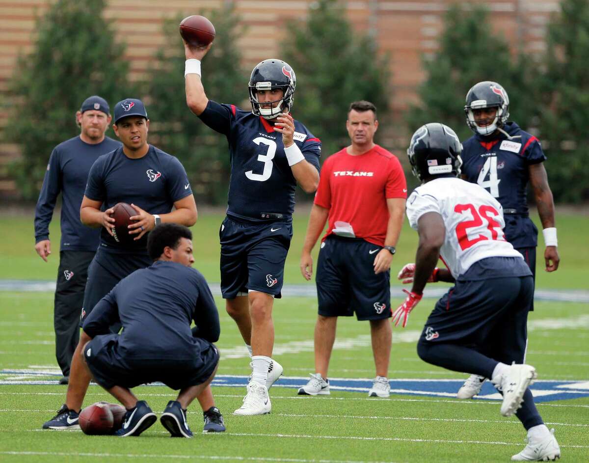 Quarterback Tom Savage (3) throws a pass to running back Lamar Miller (26) during the Texans' workout Monday morning at the Dallas Cowboys' training facility in Frisco.