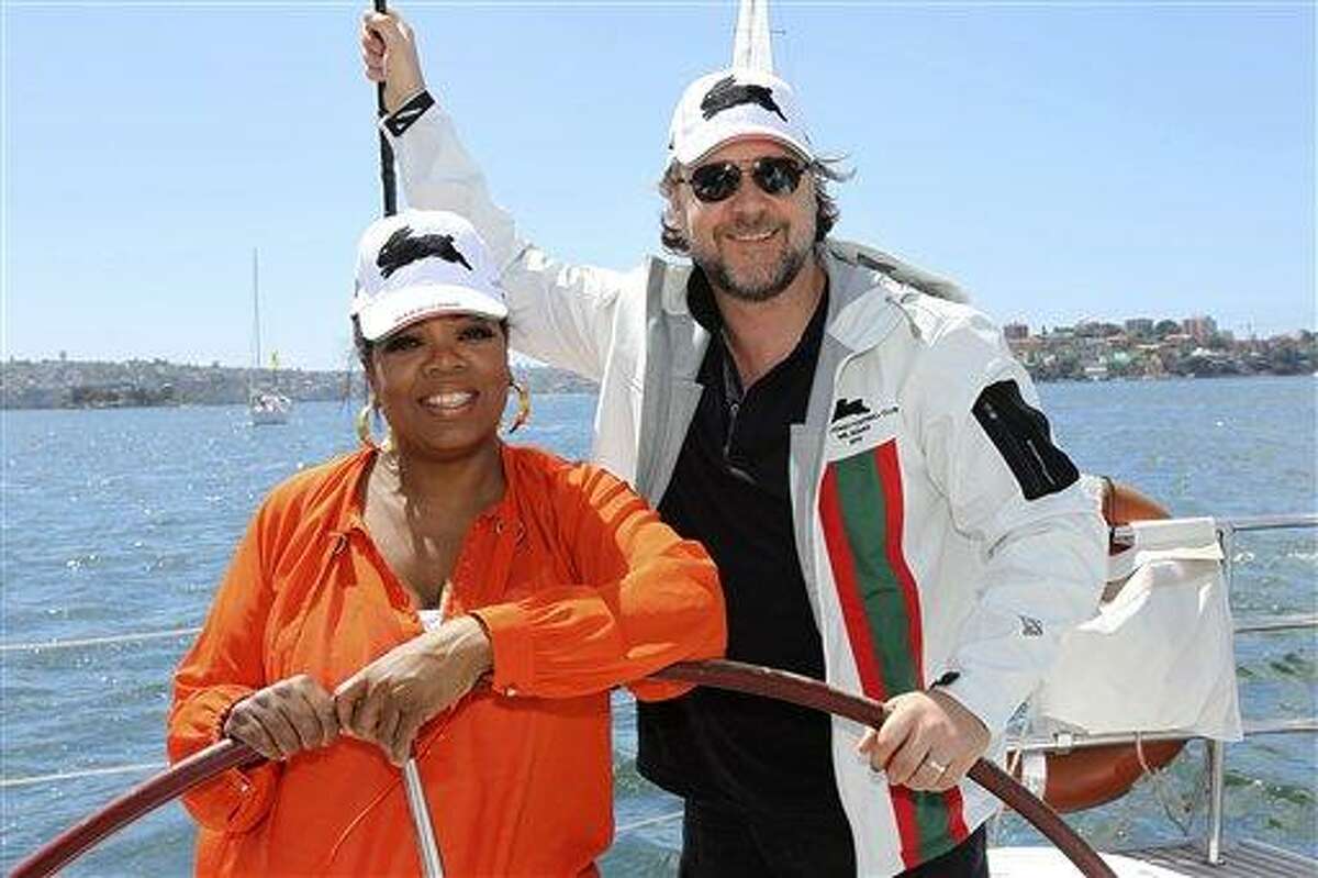In this photo released by Harpo Productions Inc., talk show host Oprah Winfrey, left, poses with actor Russell Crowe while sailing on Sydney Harbour, Monday, Dec. 13, 2010. Winfrey is taping two episodes of her show outside Sydney's Opera House, Tuesday. (AP Photo/Harpo Productions, Inc., George Burns) EDITORIAL USE ONLY
