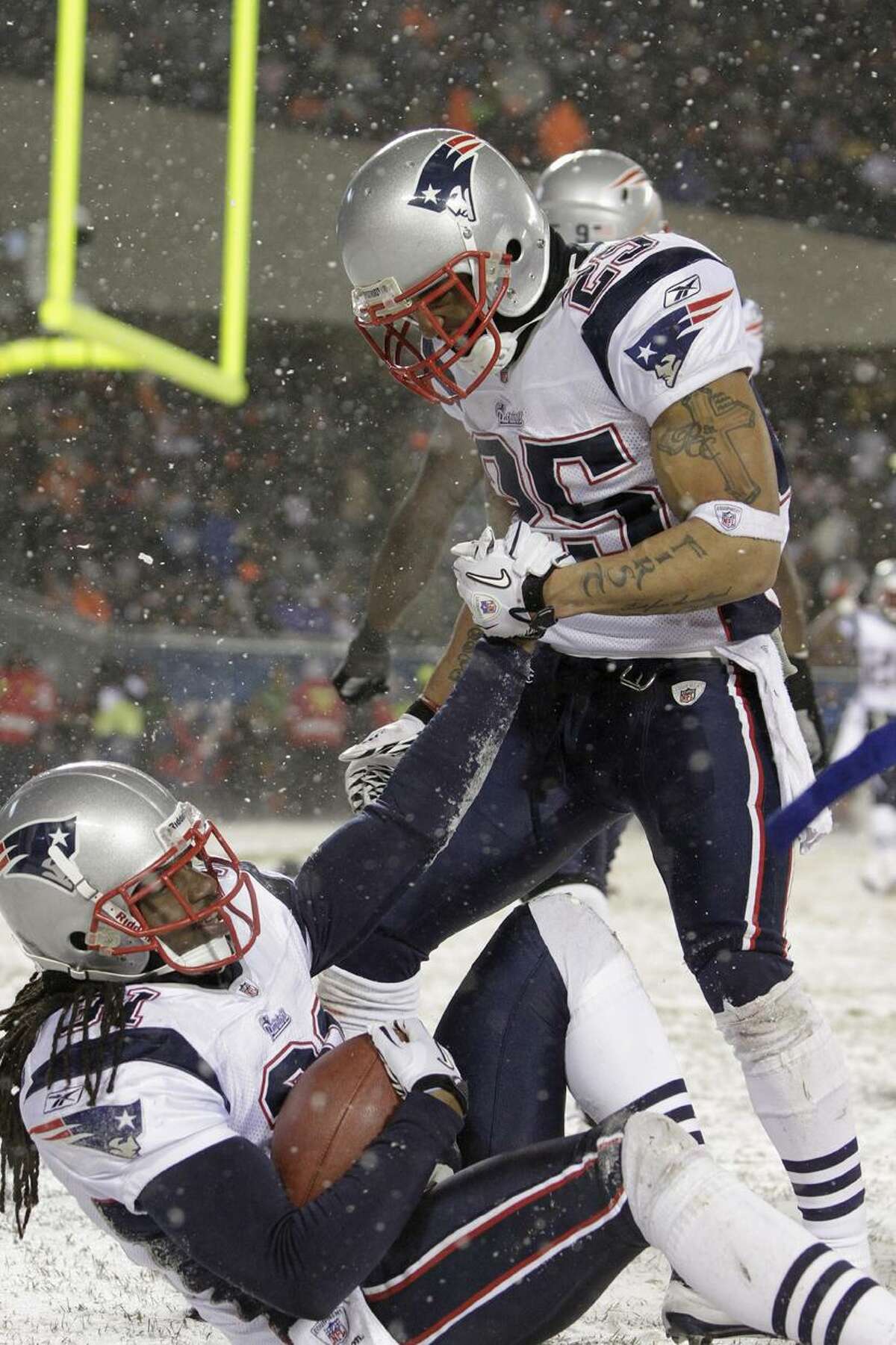 New England Patriots safety Brandon Meriweather (31) celebrates his interception in the end zone with teammate Pat Chung (25) in the second half of an NFL football gameagainst the Chicago Bears in Chicago, Sunday, Dec. 12, 2010. The Patriots won 36-7. (AP Photo/Nam Y. Huh)