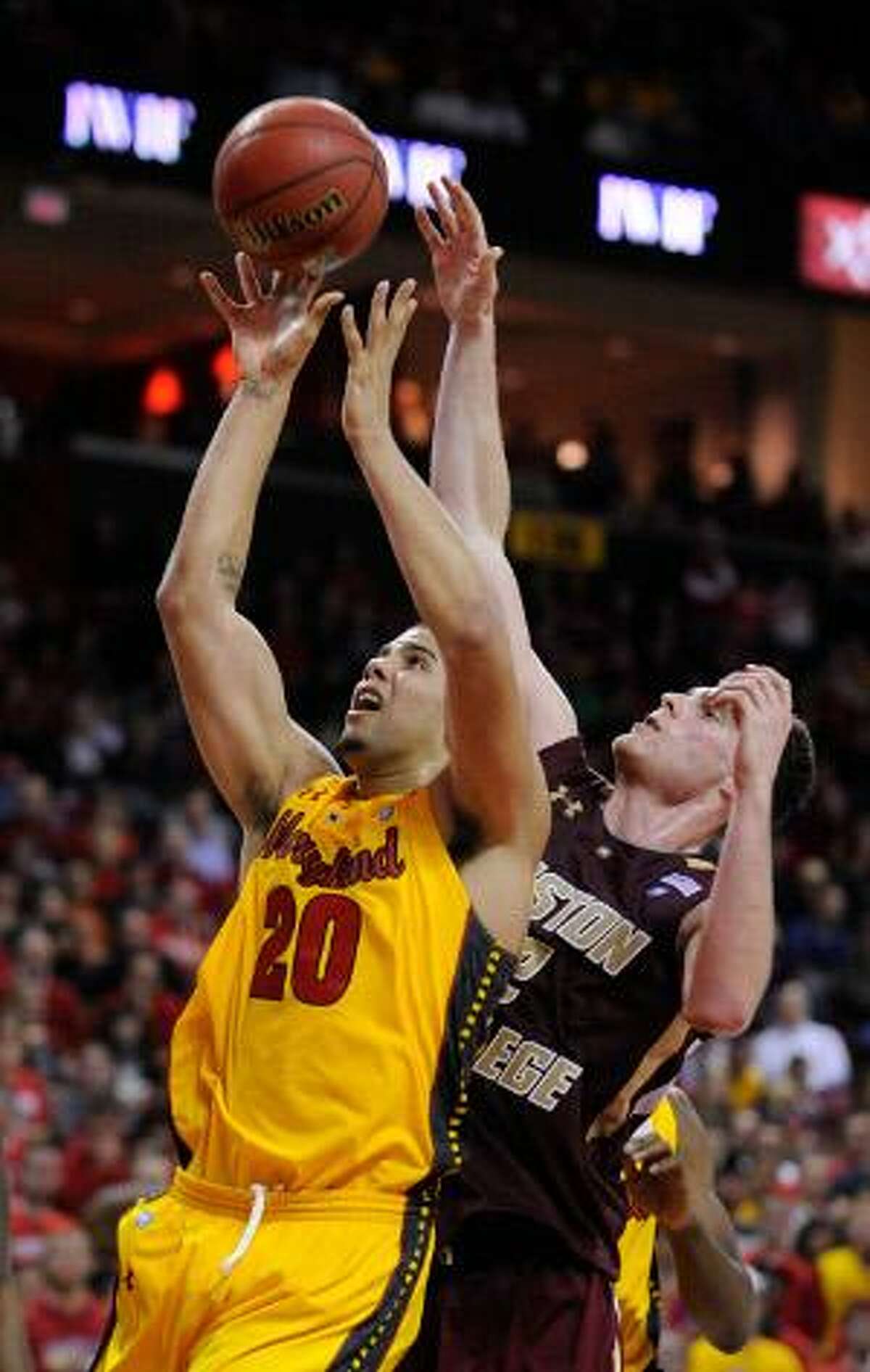 Maryland's Jordan Williams, left, shoots and is fouled by Boston College's Joe Trapani in the second half of a game, Sunday, in College Park, Md. Boston College won 79-75. (AP Photo/Gail Burton)
