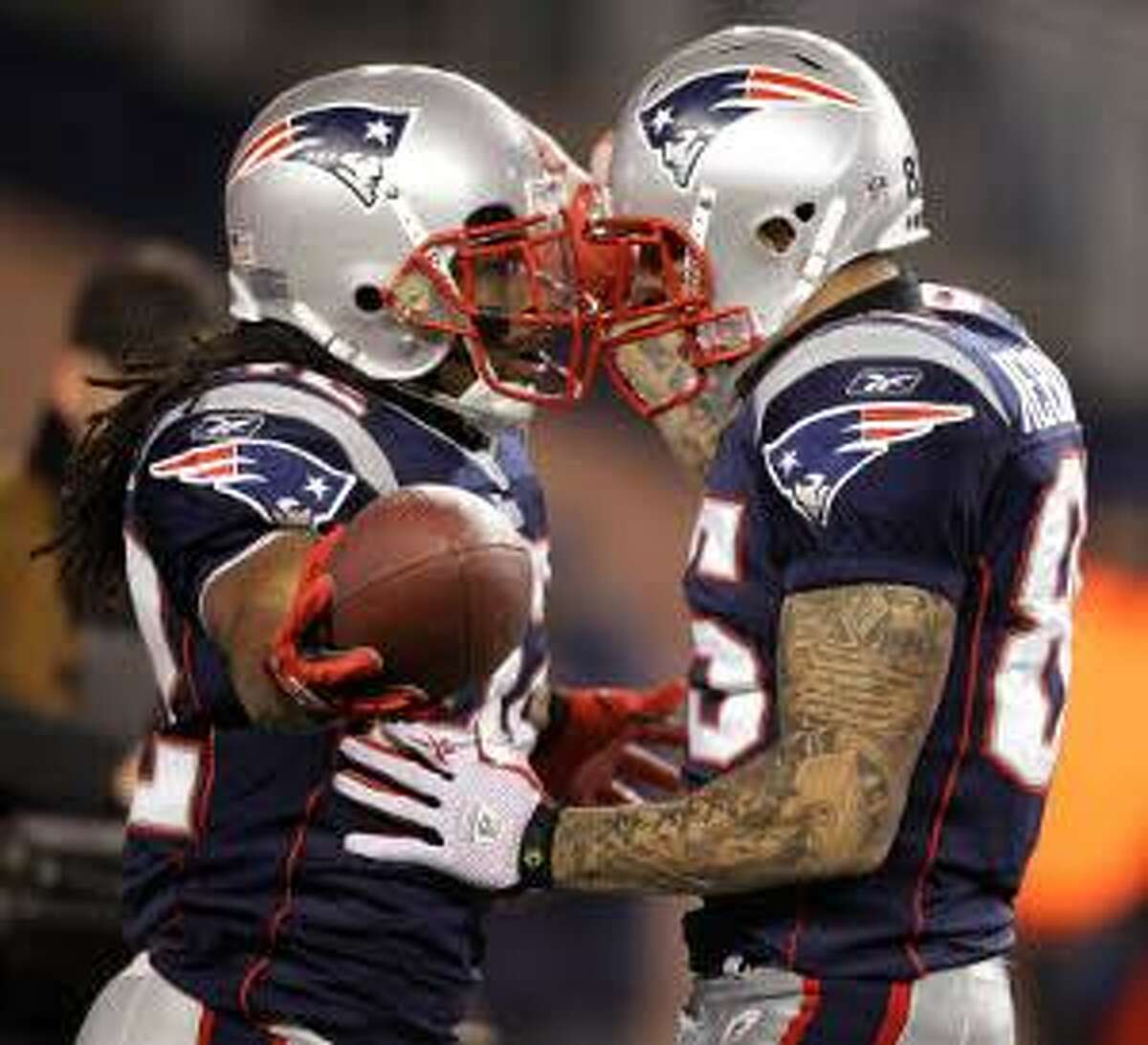 New England Patriots running back BenJarvus Green-Ellis (42) celebrates with New England Patriots tight end and Bristol native Aaron Hernandez (85) after Green-Ellis scored a rushing touchdown during the first quarter of their game against the New York Jets Monday night in Foxboro, Mass. (AP Photo/Stephan Savoia)