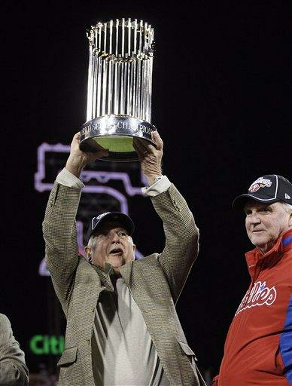 FILE - This Oct. 29, 2008, file photo shows Philadelphia Phillies general manager Pat Gillick raising the World Series trophy, as manager Charlie Manuel looks on after the Phillies beat he Tampa Bay Rays 4-3 in Game 5 to win the baseball World Series, in Philadelphia. Gillick, a former general manager whose teams won three World Series titles, has been elected to baseball's Hall of Fame, Monday, Dec. 6, 2010.(AP Photo/David J. Phillip, File)