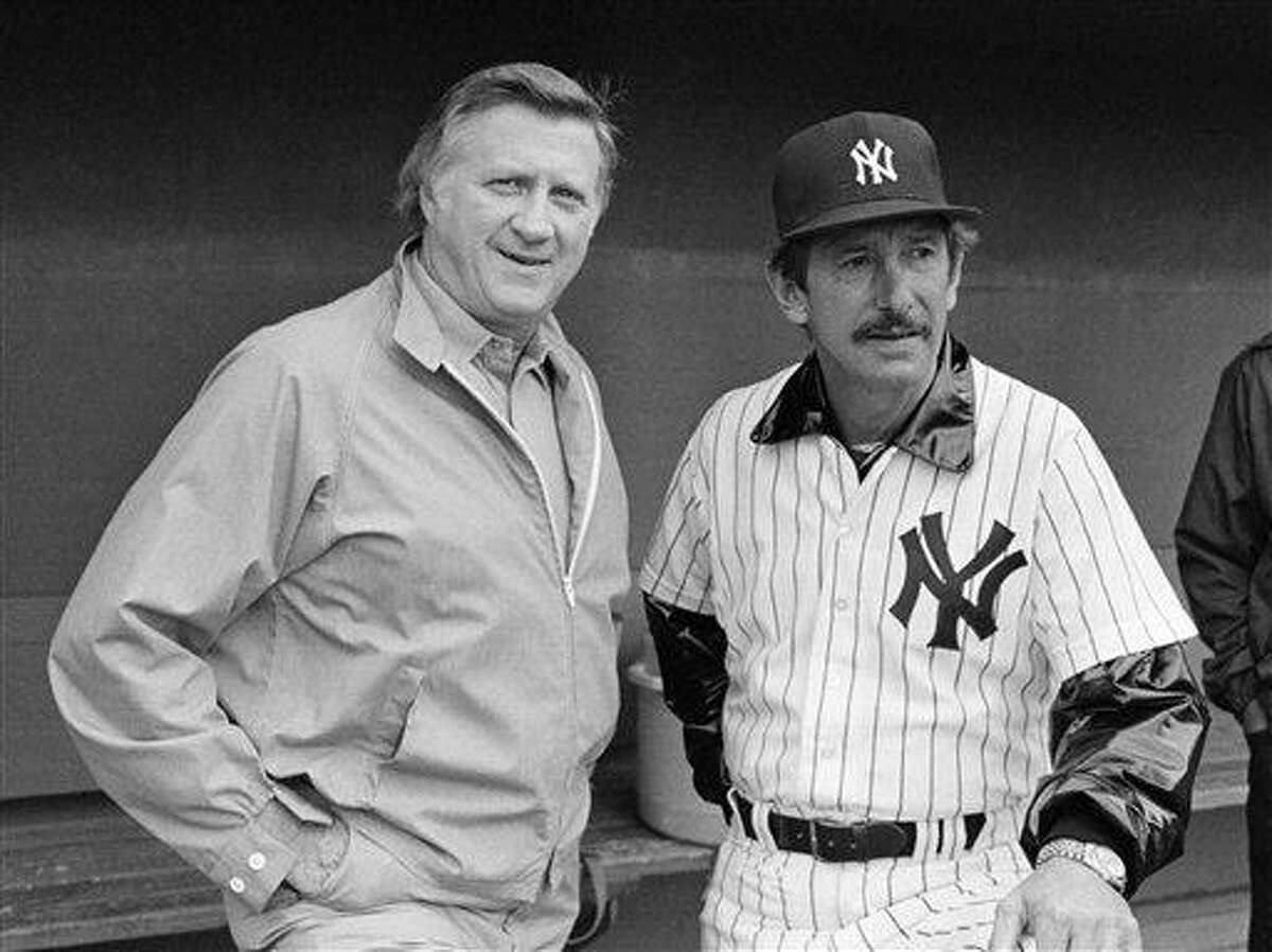 In this March 1, 1983, file photo, New York Yankees owner George Steinbrenner, left, and manager Billy Martin, get together outside the dugout at baseball spring training in Fort Lauderdale, Fla. Steinbrenner will be on the Hall of Fame veterans committee ballot next month with Martin. Steinbrenner owned the Yankees from 1973 until his death in July, and the team won seven World Series championships, 11 AL pennants and 16 AL East titles during his turbulent and blustery reign. Martin had five stints as Yankees manager under Steinbrenner, who fired him four times and let him resign once. (AP Photo/Ray Howard, File)