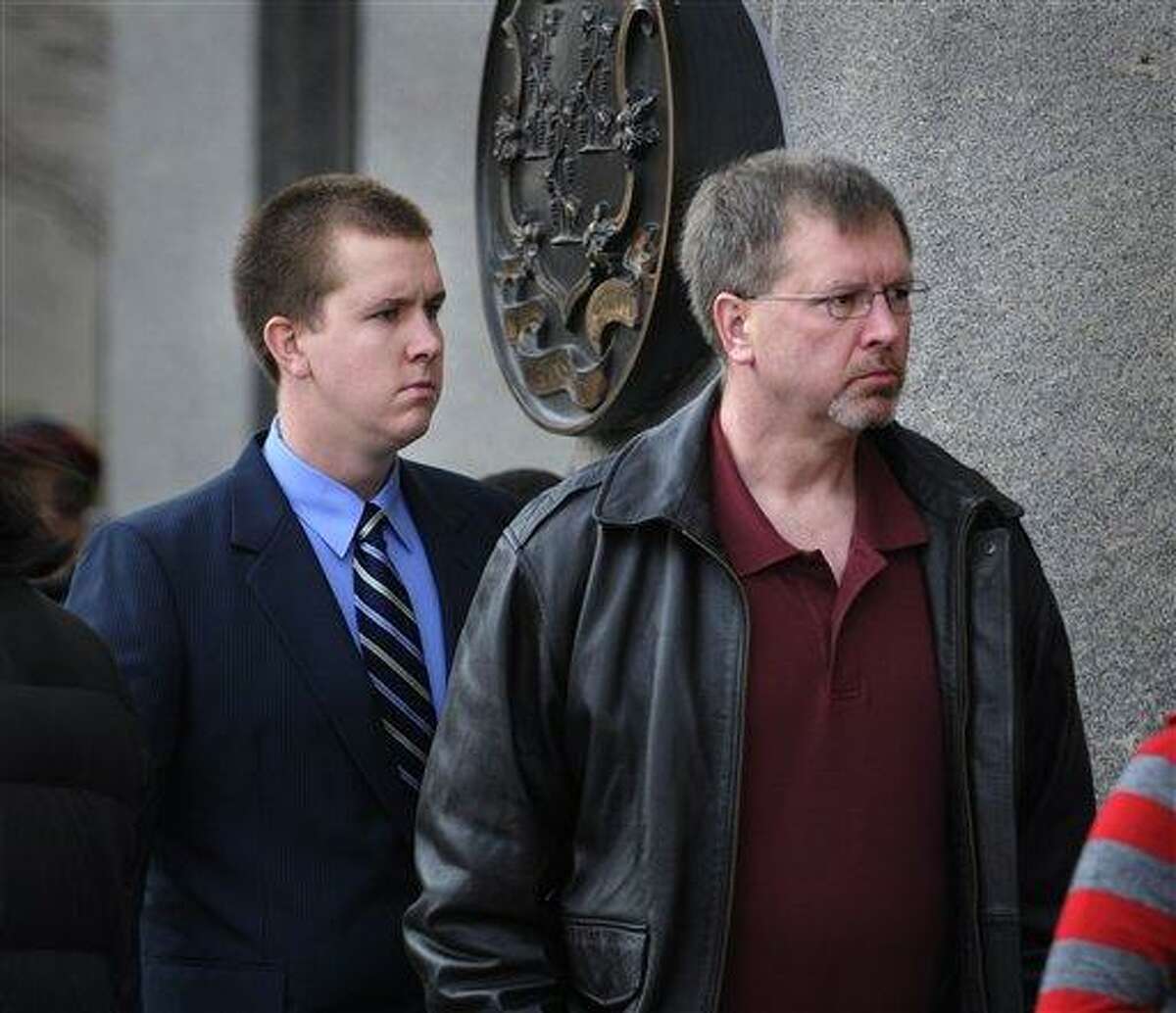 Windsor Locks police officer Michael Koistenen, left, walks into Hartford Superior Court Tuesday, Nov. 23, 2010 with his father, Windsor Locks Police Sgt. Robert Koistenen, for his arraignment hearing. Michael Koistenen pleaded not guilty to manslaughter charges in the death of a 15-year-old boy who was riding his bike home from a friend's house when police say he was hit by a speeding car. (AP Photo/The Hartford Courant, Stephen Dunn)