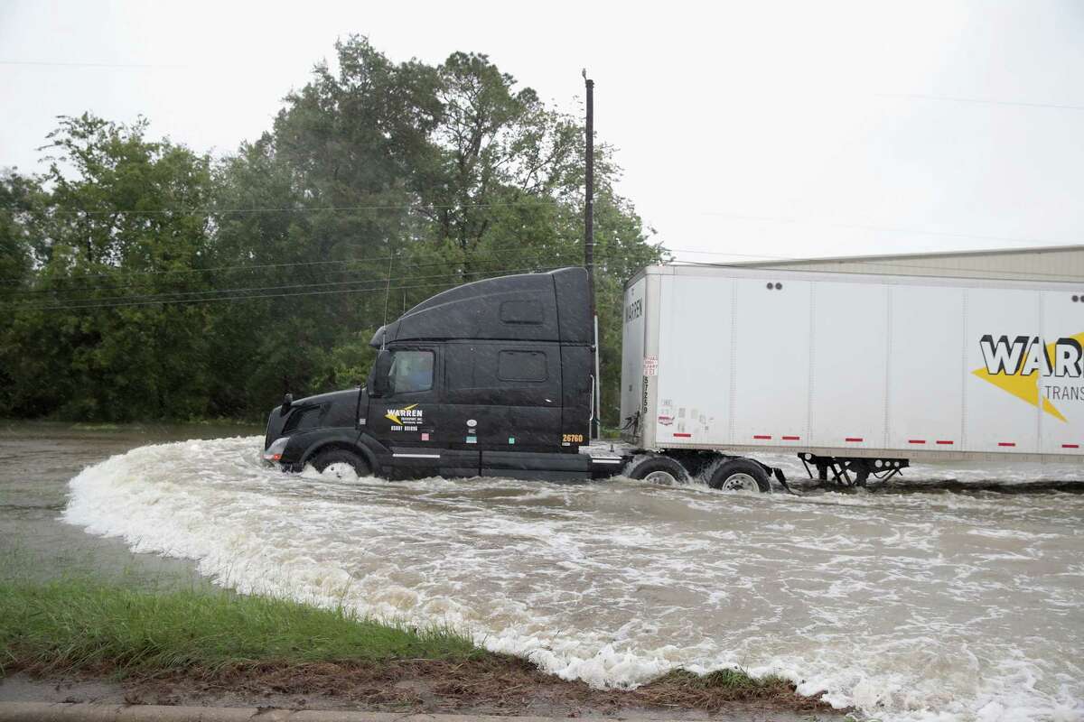 HOUSTON, TX - AUGUST 28: A truck navigates a road flooded with rain water, remnants of Hurricane Harvey, on August 28, 2017 in Houston, Texas. Harvey, which made landfall north of Corpus Christi late Friday evening, is expected to dump upwards to 40 inches of rain in areas of Texas over the next couple of days.