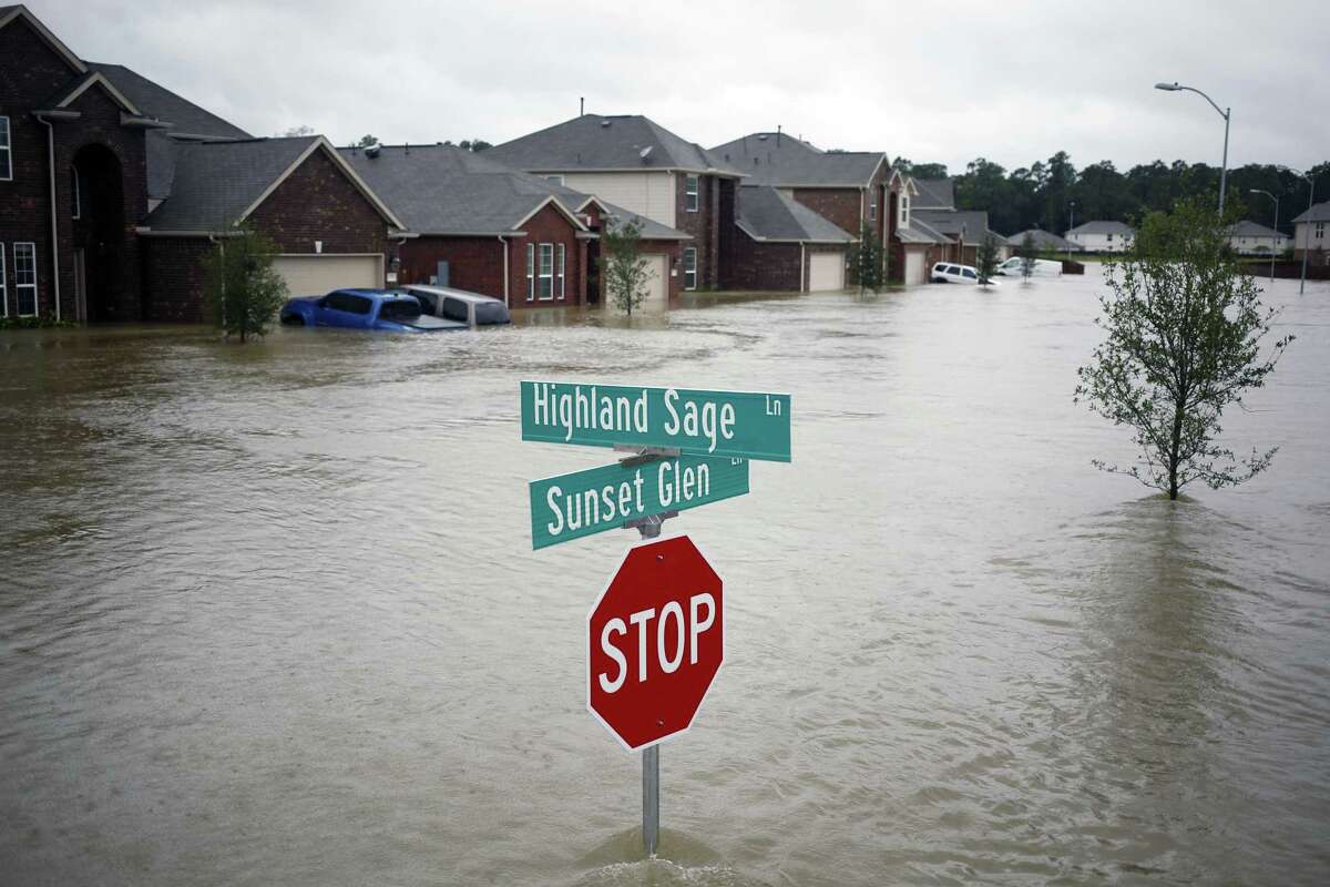 Houses at the Highland Glen subdivision stand in floodwaters due to Hurricane Harvey in Spring, Texas, U.S., on Monday, Aug. 28, 2017. A deluge of rain and rising floodwaters left Houston immersed and helpless, crippling a global center of the oil industry and testing the economic resiliency of a state that's home to almost 1 in 12 U.S. workers. Photographer: Luke Sharrett/Bloomberg