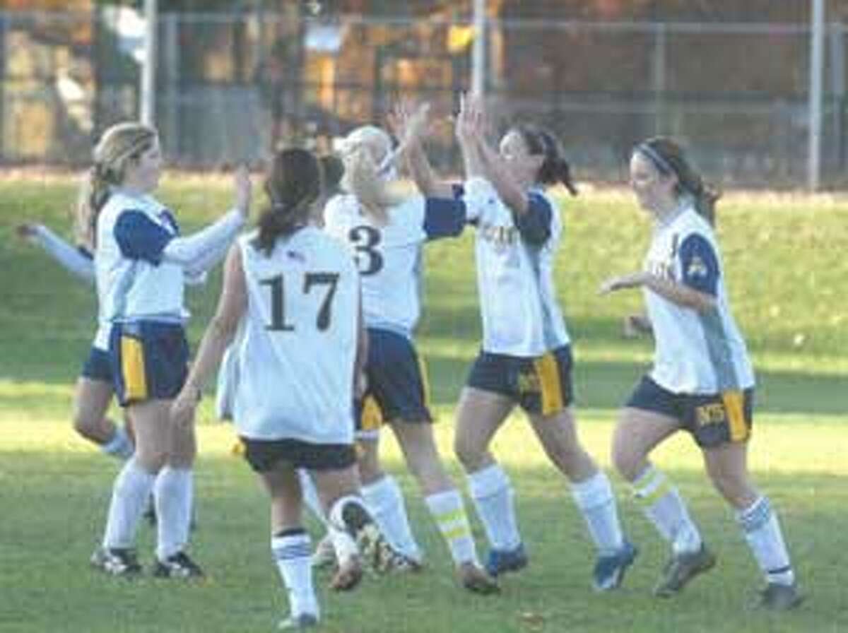 The Wolcott Tech girls soccer team celebrates after scoring a goal Thursday in its 8-0 win over Thomaston in Torrington.