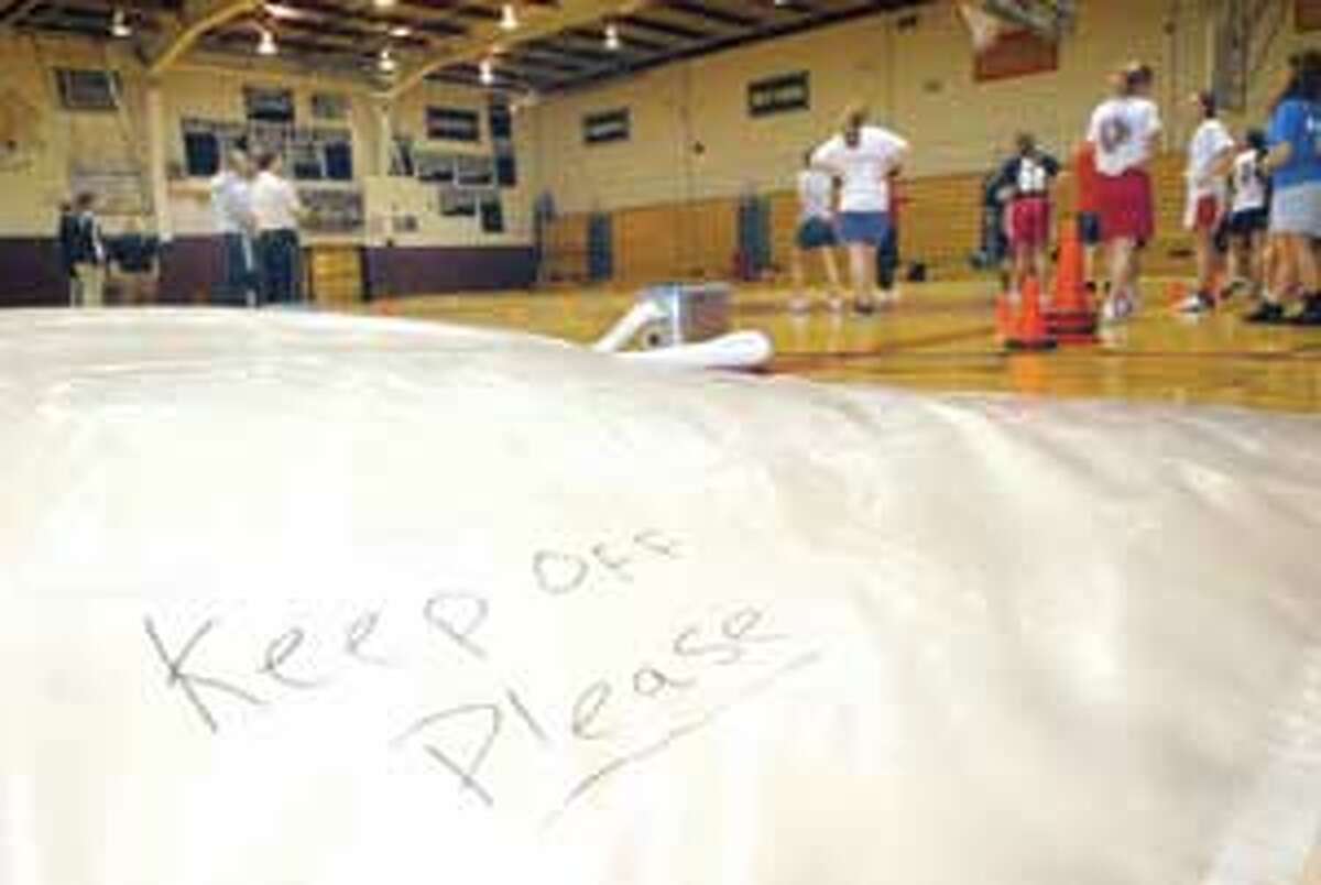 MIC NICOSIA/Register Citizen Winter sports conditioning training takes place on Wednesday in the Torrington High School gymnasium, which is still only partially usable as a result of water damage.