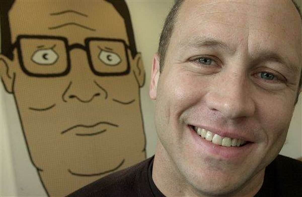 Mike Judge, co-creator of the Fox cartoon series "King of the Hill," poses in front of an illustration of Hank Hill, the animated character he voices, in this Oct. 28, 2002, file photo made in Los Angeles. "King of the Hill" is over the hill at Fox, which is canceling the long-running animated comedy. Final episodes of the half-hour series, now in its 13th year, likely will air during the 2009-10 season, Fox said Friday Oct. 31, 2008. (AP Photo/Ric Francis, FILE)