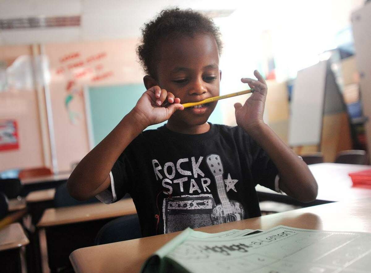 Nazir Mitchell, 4, works on his letters in his kindergarten class on the first day of the Lighthouse summer program at Luis Munoz Marin School in Bridgeport, Conn. on Wednesday, July 5, 2017. The city Board of Education narrowly approved the program, a fixture in city schools since it's founding in 1993.