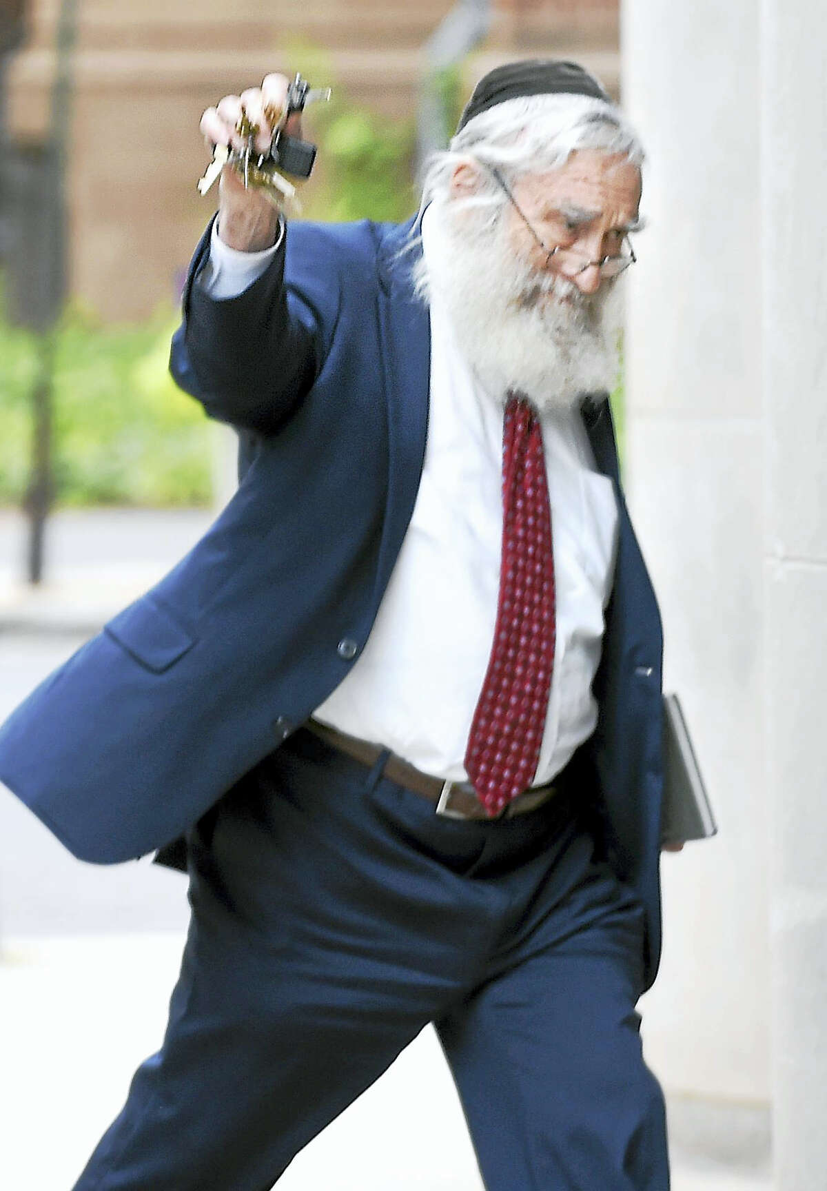 Rabbi Daniel Greer is photographed leaving Superior Court in New Haven Tuesday after not guilty pleas were entered to charges of second-degree sexual assault and risk of injury to a minor.