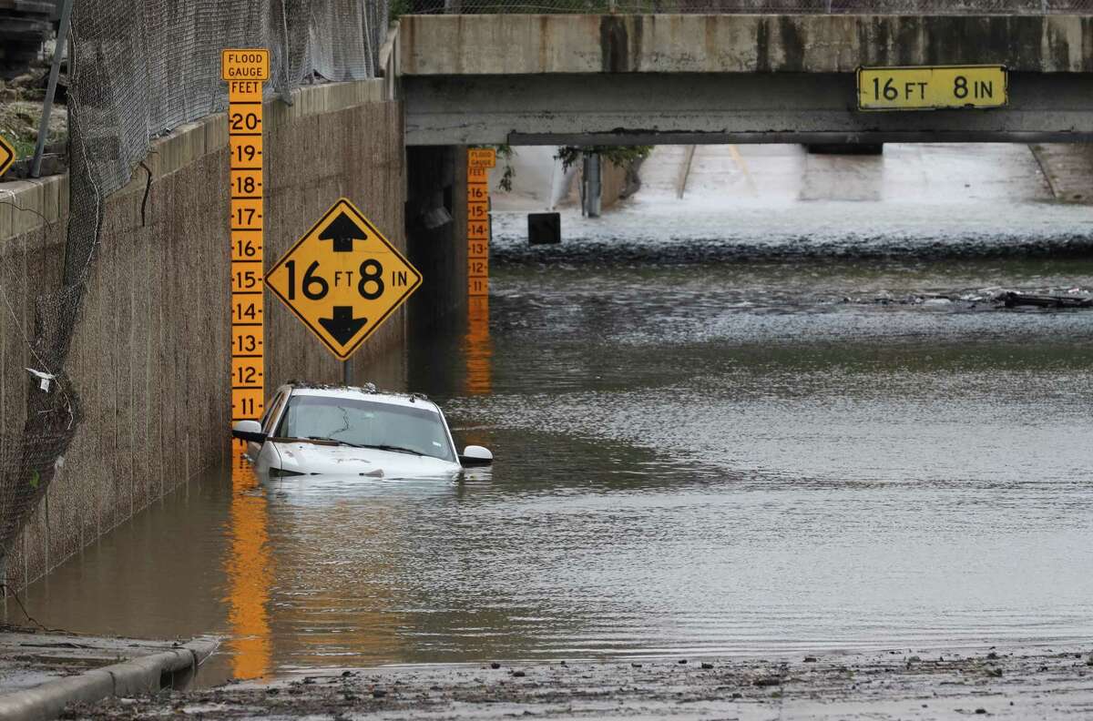 A submerged vehicle is seen at the intersection of the Hardy Toll Road and the Sam Houston Tollway, as heavy rains continue from Tropical Storm Harvey, Tuesday August 29, 2017, in Houston. An HPD officer reportedly drowned in his patrol car at the intersection while on his way to work.