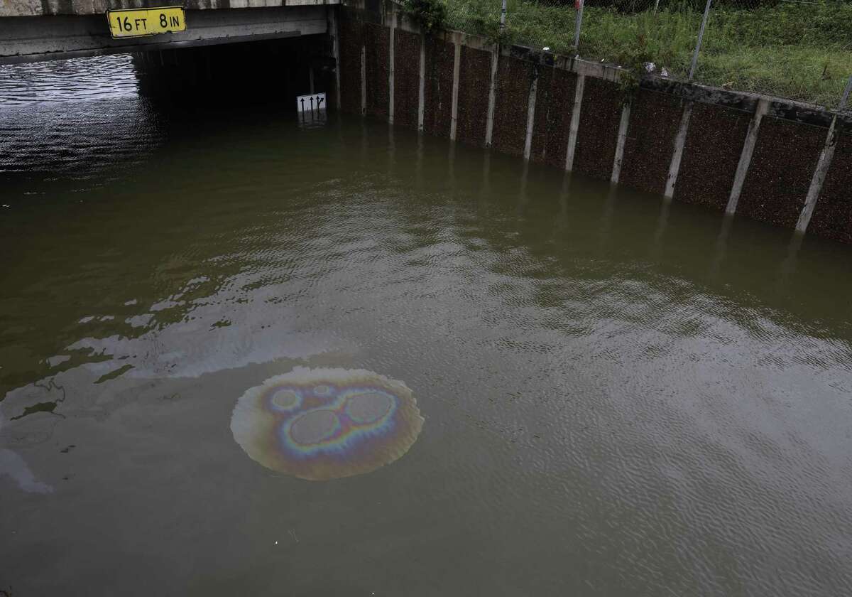 Fluids from a submerged vehicle rise to the surface at the intersection of the Hardy Toll Road and the Sam Houston Tollway, as heavy rains continue from Tropical Storm Harvey, Tuesday August 29, 2017, in Houston. Sgt. Steve Perez, 56, reportedly drowned in his patrol car at the intersection while on his way to work. He was a 30-year veteran of the HPD. 
