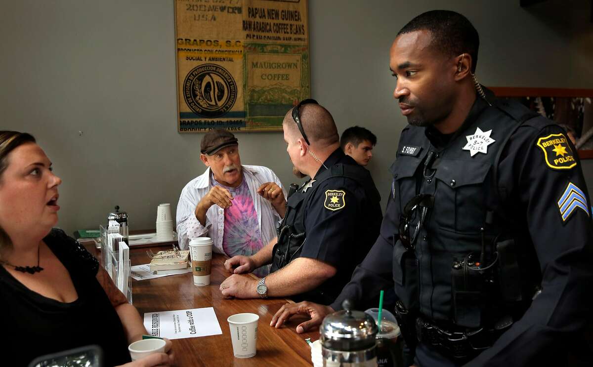Fred Dodsworth, (left center) talks with Berkley Police officer Brandon Smith, (right center) while Saschenka Wasko-Jones, (left) talks with with Sgt. Jumaane Fomby, (right) by during a "Coffee with a Cop" event at Starbucks in Berkeley, Ca. on Tues. August 29, 2017. No agenda or speeches, just a chance for the public to ask questions, share concerns, and meet some of the Berkeley police officers who work to keep the neighborhoods safe.