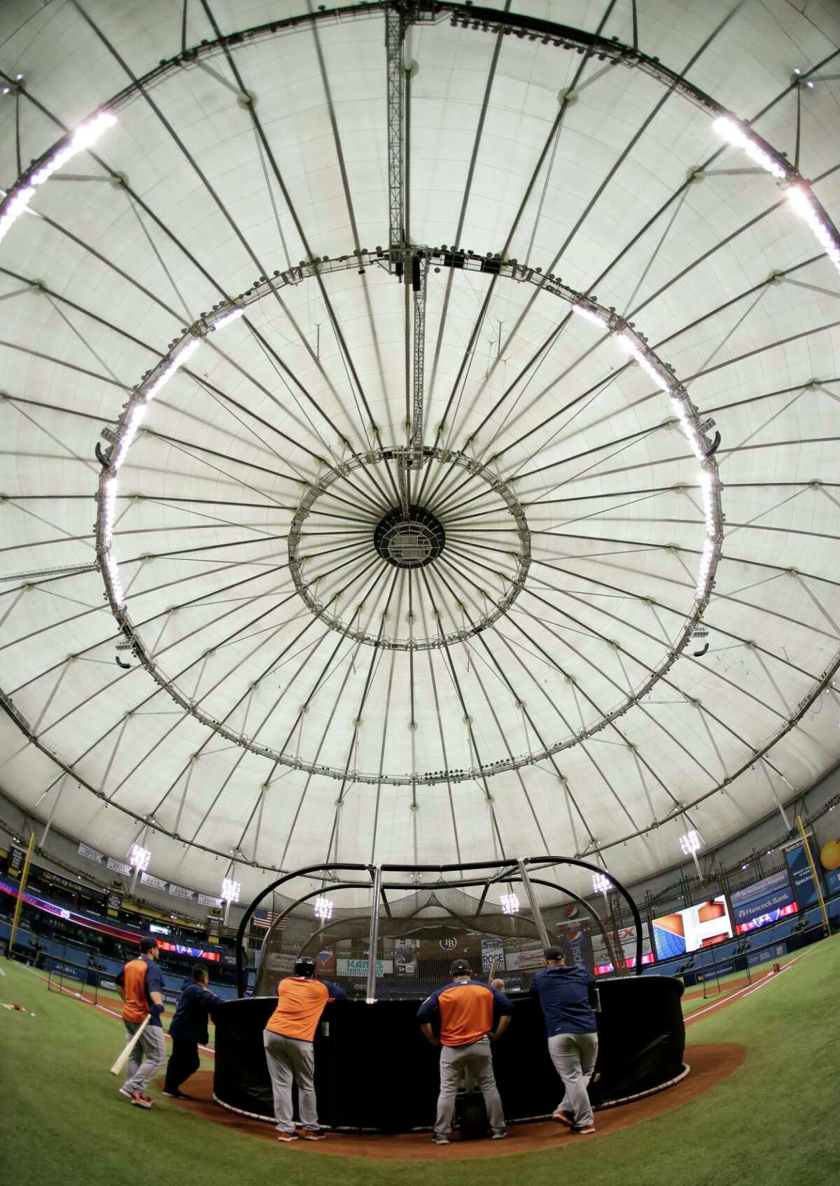Houston Astros coaches watch batting practice before a baseball game against the Texas Rangers Tuesday, Aug. 29, 2017, in St. Petersburg, Fla. The Astros moved their three game home series against the Rangers to St. Petersburg because of unsafe conditions from Hurricane Harvey. (AP Photo/Chris O'Meara)