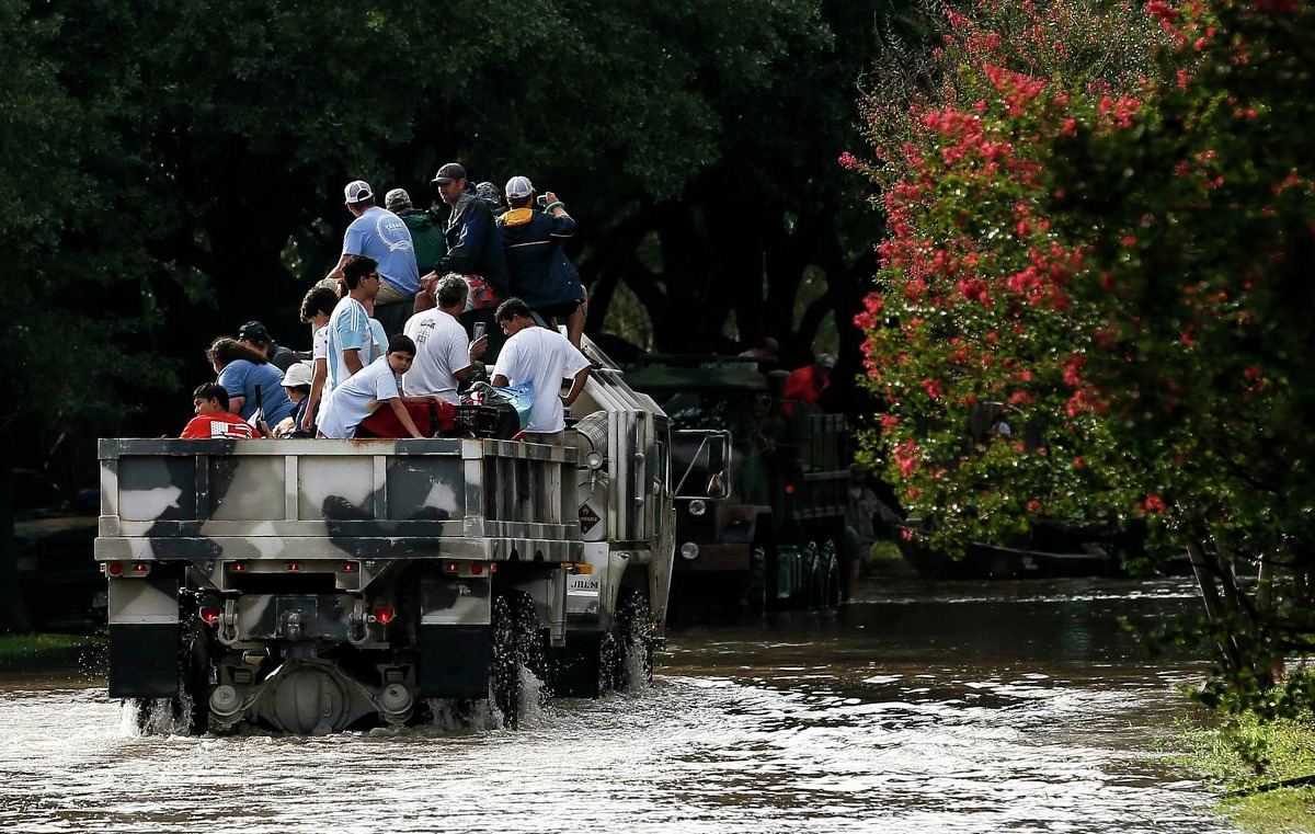 Volunteer rescuers evacuate people from the Georgetown Colony neighborhood on a Heavy Expanded Mobility Tactical Truck, which was used as a prop in the latest Planet of the Apes movie, as Addicks Reservoir surpasses capacity due to near constant rain from Tropical Storm Harvey Tuesday, Aug. 29, 2017 in Houston.