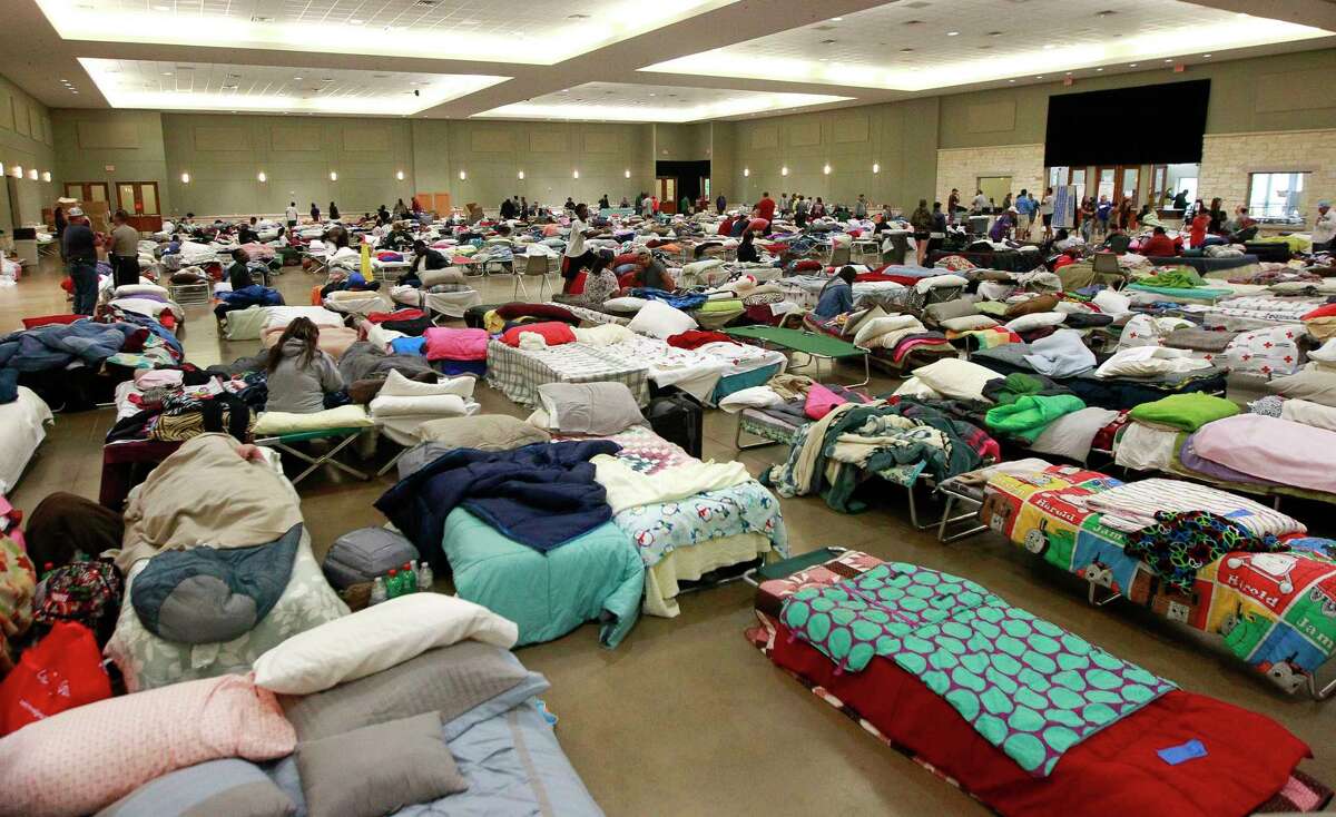 Evacuees from Tropical Storm Harvey seek shelter at the Lone Star Convention and Expo Center, Tuesday, Aug. 29, 2017, in Conroe.