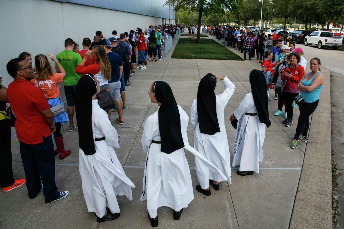 Dominican Sisters of Mary Immaculate Province join a line of people waiting to volunteer at NRG Center, which opened its doors to a capacity of 10,000 evacuees in the wake of Tropical Storm Harvey Wednesday, Aug. 30, 2017 in Houston.