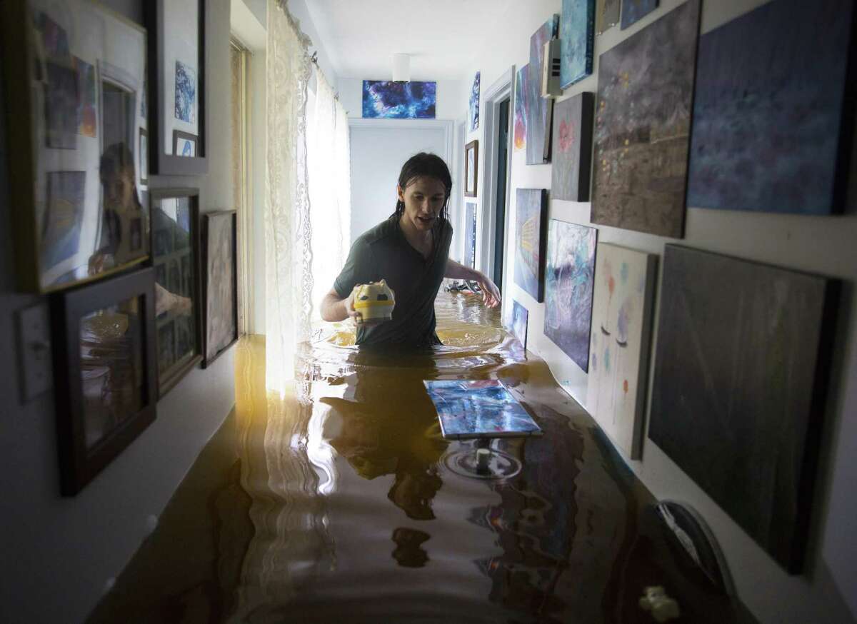 Matthew Koser wades through his grandfather’s house in West Houston after it was flooded by heavy rains from Harvey. Owners of flooded houses and businesses will have to deal with a lack of skilled construction workers at a time they need help the most.