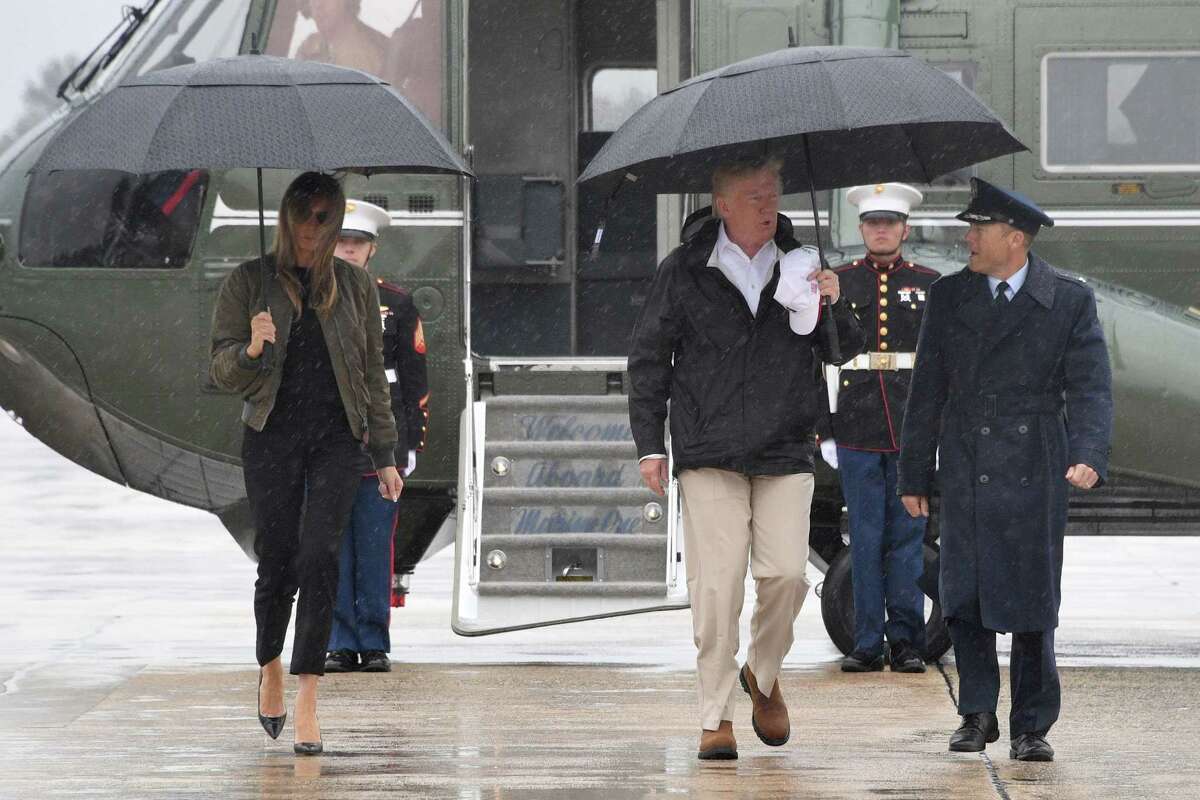 TOPSHOT - US President Donald Trump and First Lady Melania Trump walk to board Air Force One at Andrews Air Force Base, Maryland, on August 29, 2017 en route to Texas to view the damage caused by Hurricane Harvey. / AFP PHOTO / JIM WATSONJIM WATSON/AFP/Getty Images