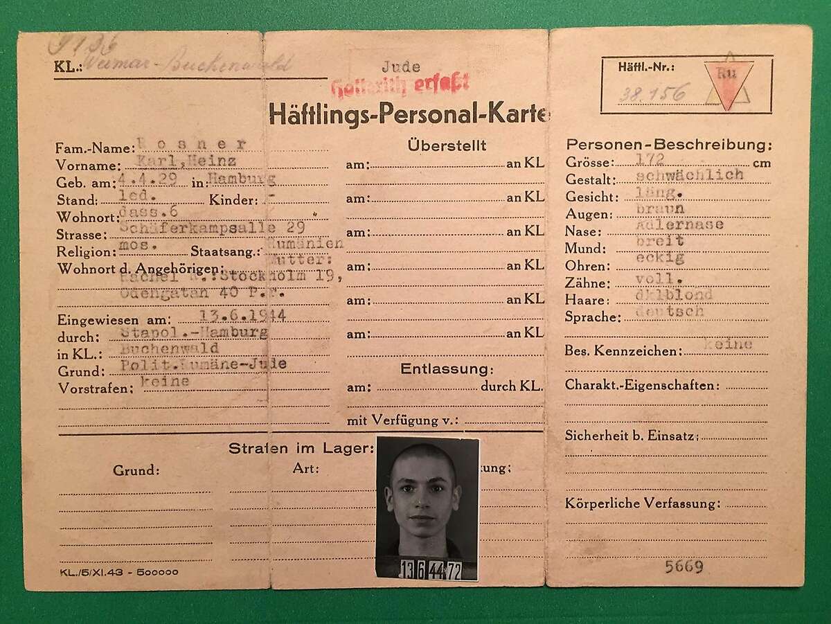 There is a closeup of Karl Rosner's prisoner card, his actual star, the patch he wore after liberation to ID prisoners, and his prison number patch.