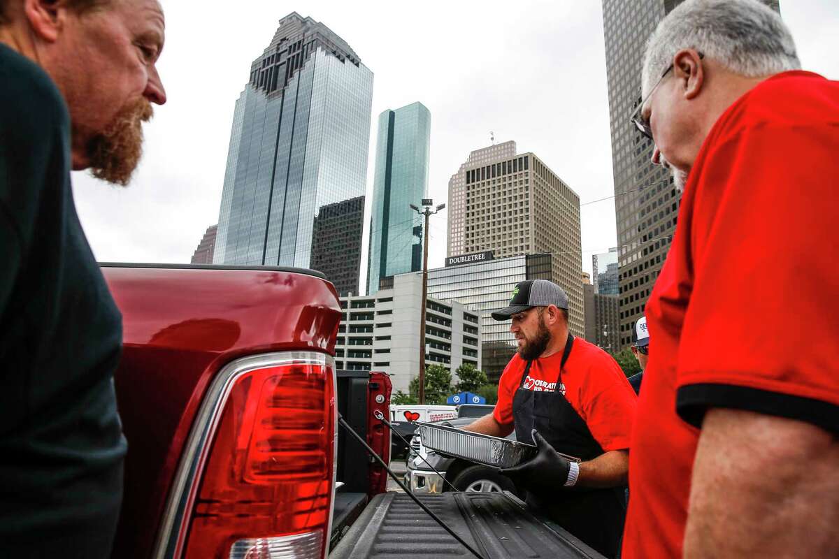 Operation BBQ Relief volunteer Joshua Wilkinson packs BBQ into the back of a truck for delivery Wednesday, Aug. 30, 2017 in Houston. The volunteer operation aims cook meals that will feed at least half a million people over the course of 10 days. ( Michael Ciaglo / Houston Chronicle)