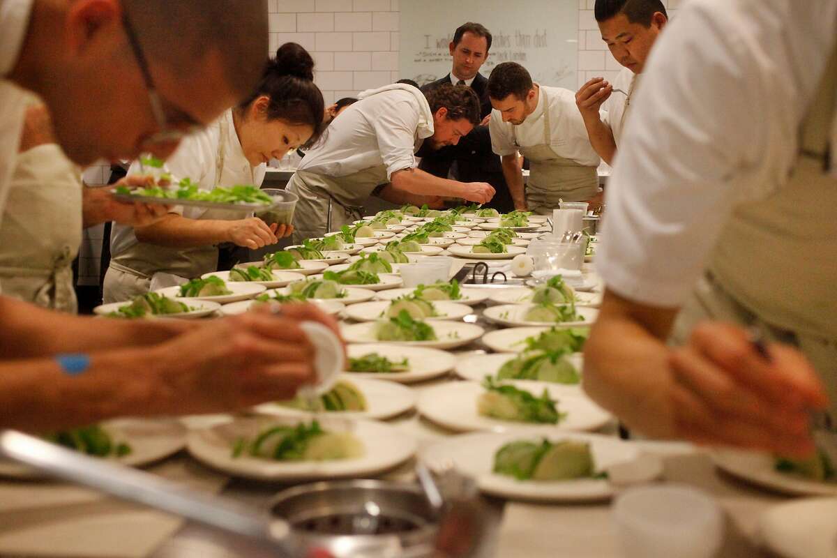 Guest Chef Kobe Desramaults, center, of In De Wulf, plates food with the help of the kitchen staff for dinner in The Restaurant at Meadowood Napa Valley during their annual Twelve Days of Christmas guest chef event Dec. 9, 2014 in St. Helena, Calif.
