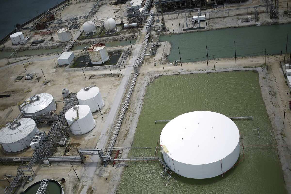 Rainwater from Hurricane Harvey surrounds an oil storage tank near an oil refinery in this aerial photograph taken above Texas City, Texas, U.S., on Wednesday, Aug. 30, 2017. Unprecedented flooding from the Category 4 storm that slammed into the state's coast last week, sending gasoline prices surging as oil refineries shut, may also set a record for rainfall in the contiguous U.S., the weather service said Tuesday. Photographer: Luke Sharrett/Bloomberg