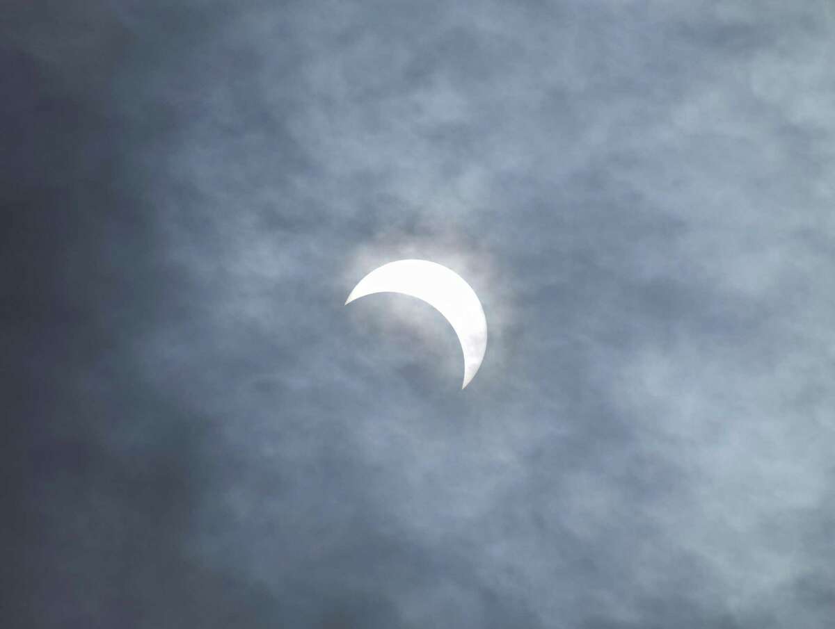 The 2017 partial solar eclipse as seen from the Great Captain Island lighthouse in Greenwich, Conn. Monday, Aug. 21, 2017. About 70 percent of the sun's surface was covered by the moon at time of peak coverage, which occured at 2:45 p.m. in Greenwich. Crowds with special solar glasses and homemade pinhole solar viewers gathered at the Bowman Observatory and Greenwich Point Park to see the rare marvel.