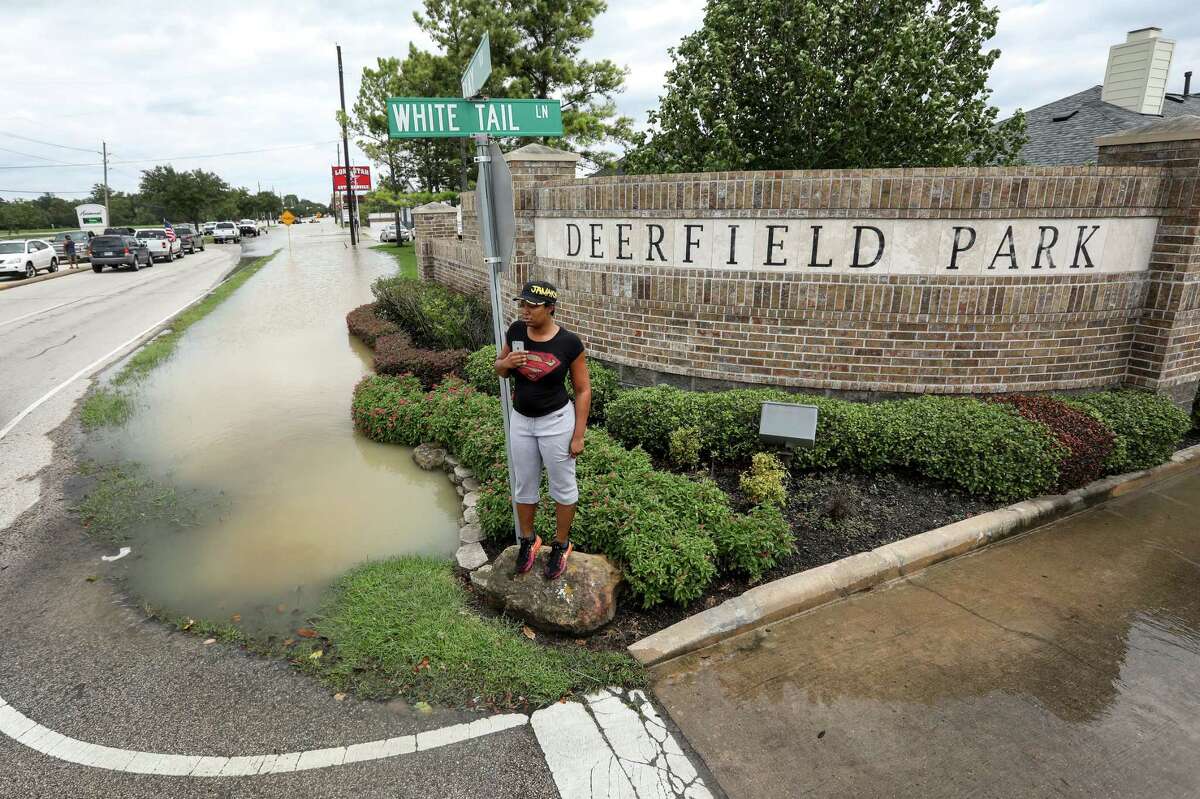 Tiffany Carroll waits anxiously by the entrance to her neighborhood, where water from the Addicks Reservoir has risen quickly, Wednesday, Aug. 30, 2017, in Houston.