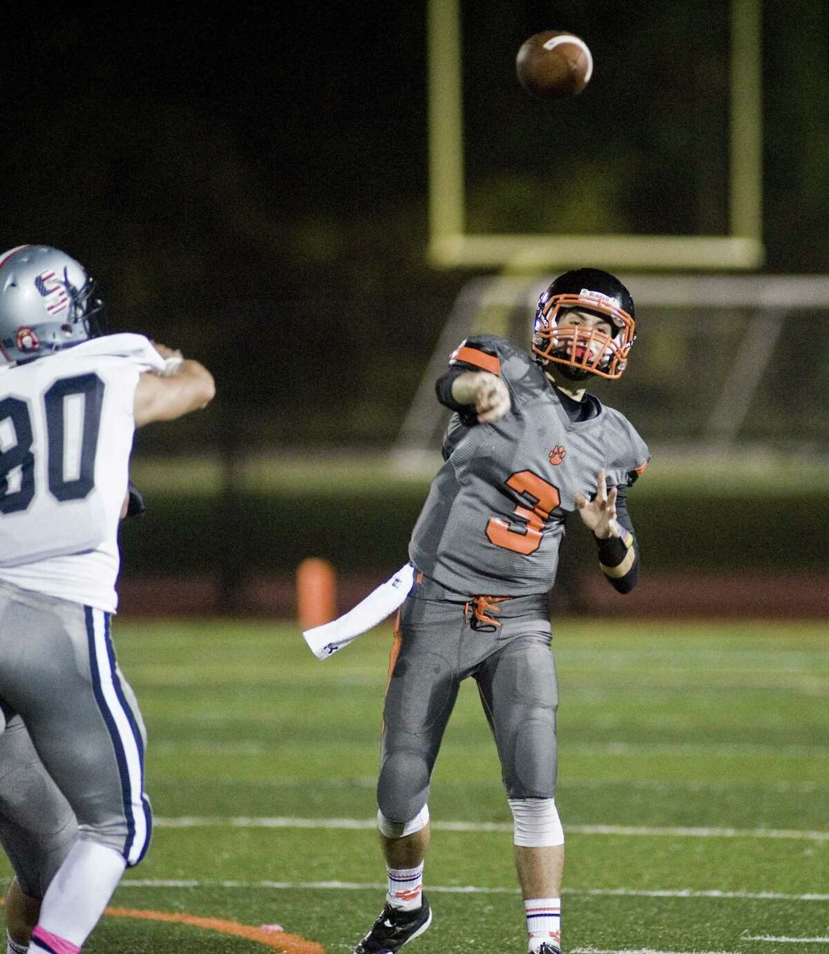 Ridgefield High School quarterback Gregory Gatto fires a pass in a game against Staples High School, played at Ridgefield. Friday, Oct. 21, 2016