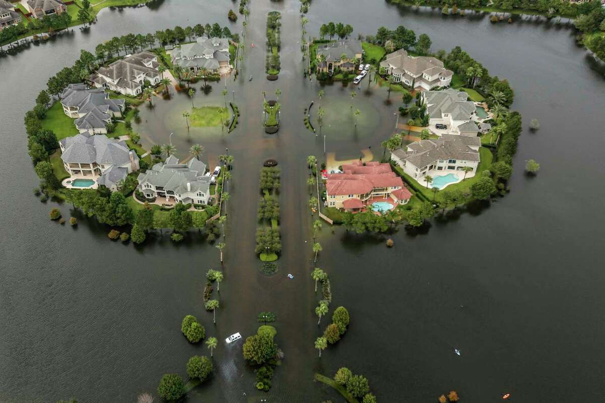 Floodwaters fill the road running through the Lakes On Eldridge North subdivision in the aftermath of Tropical Storm Harvey on Wednesday, Aug. 30, 2017, in Houston.