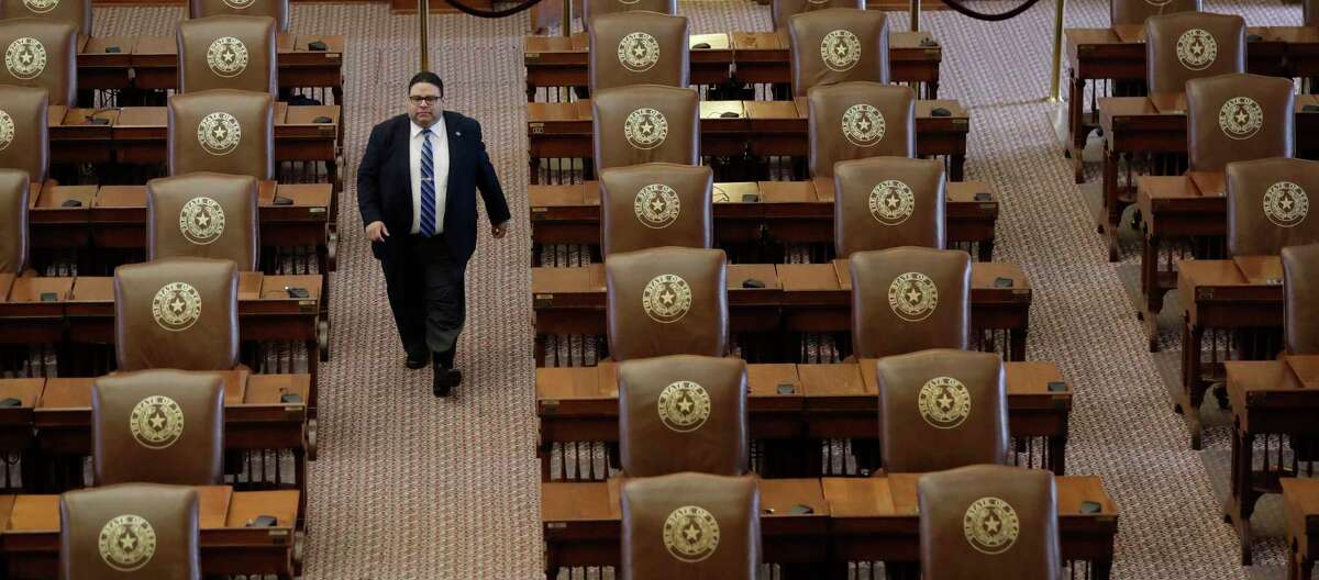 Texas House of Representatives Sergeant-at-Arms David Sauceda walks through an empty chamber on Aug. 16. (AP Photo/Eric Gay)