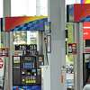 A worker changes the price board above the gas pumps at a Sunoco gas station on Monday, Aug. 28, 2017, in Latham, N.Y. (Paul Buckowski / Times Union)