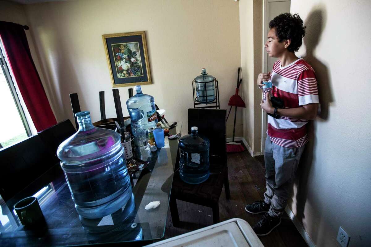 Darrel Rosales, 14, takes a break from cleaning up his flood-damaged home in the aftermath of Tropical Storm Harvey in the Verde Forest subdivision on Thursday, Aug. 31, 2017, in Houston. His family evacuated to the Toyota Center.
