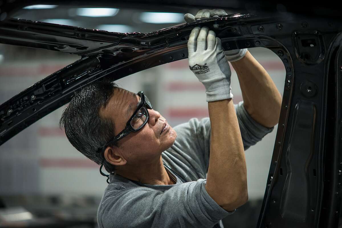 FEBRUARY 4, 2015 FREMONT, CA Workers assemble cars on the line at Tesla's factory in Fremont. David Butow (Photo by David Butow/Corbis via Getty Images)