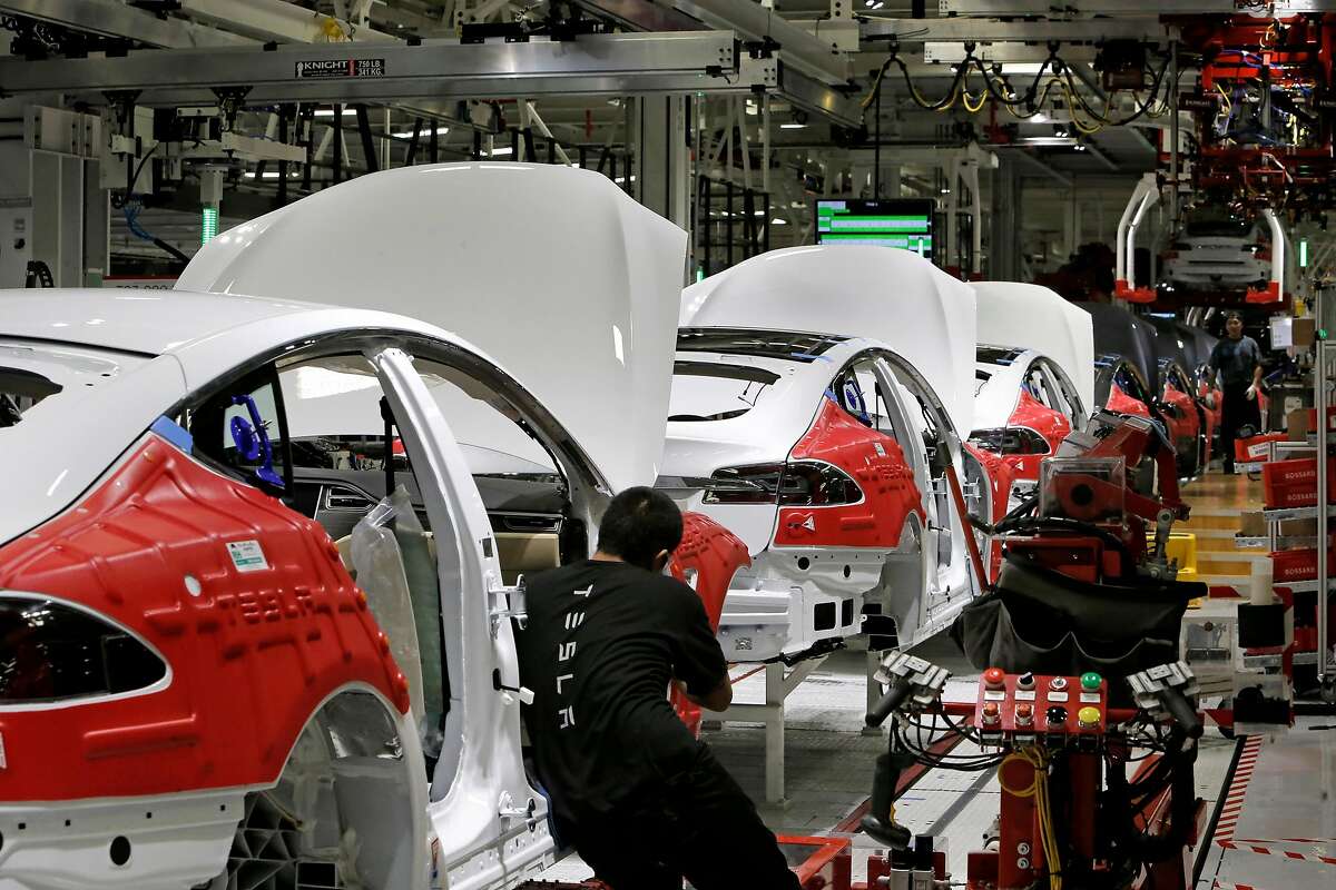 Cars move through the assembly line at Tesla Motors, California's only full-scale auto manufacturing plant, as seen on Thurs. Feb. 19, 2015, in Fremont, Calif.
