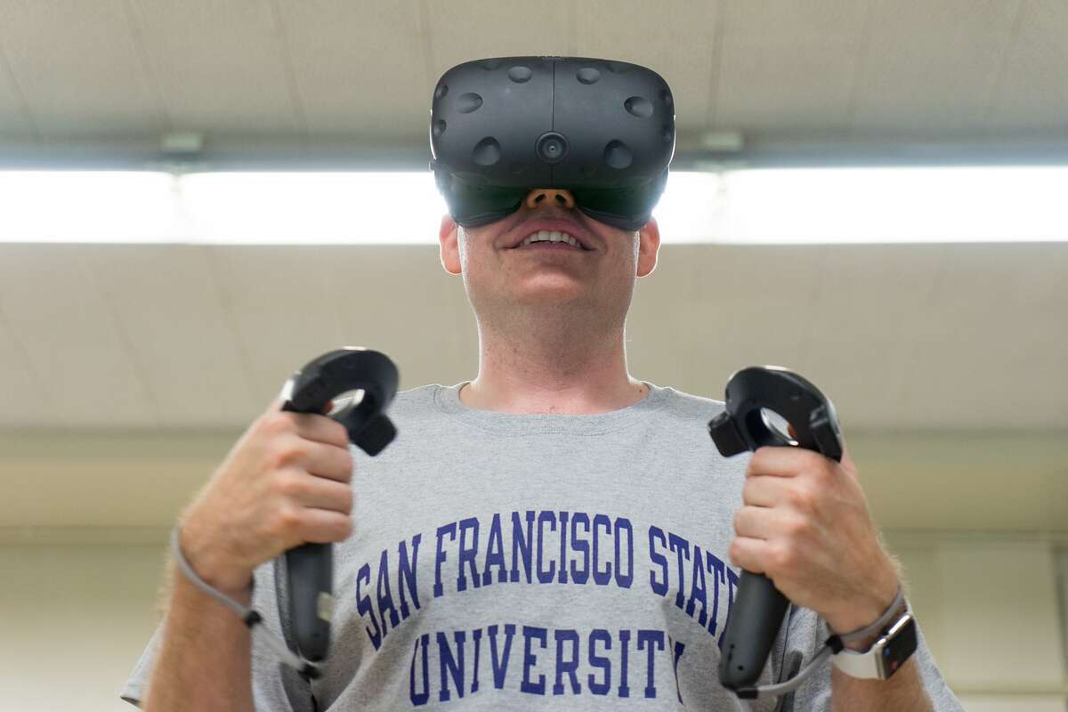 Aaron Stanton exercises using a virtual reality headset at San Francisco State University on Monday, Aug. 21, 2017. Researchers at the university are studying how effective exercising using virtual reality can be.