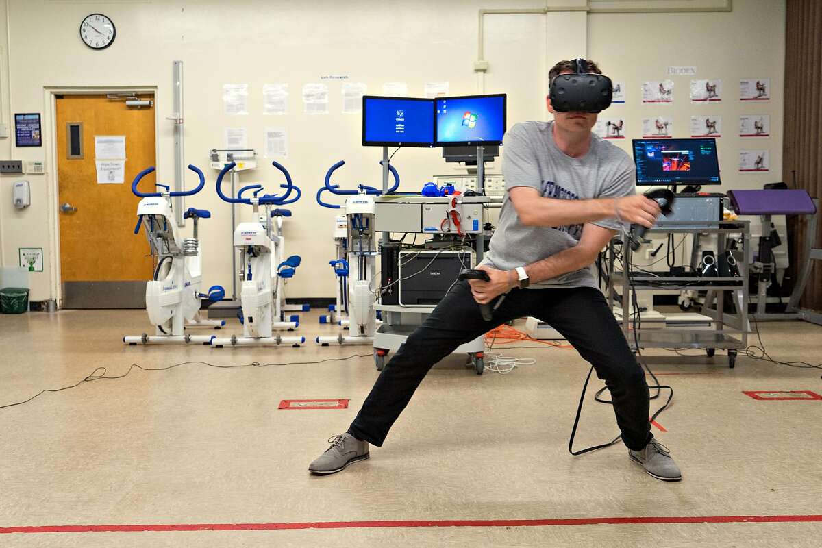 Aaron Stanton exercises using a virtual reality headset at San Francisco State University on Monday, Aug. 21, 2017. Researchers at the university are studying how effective exercising using virtual reality can be.